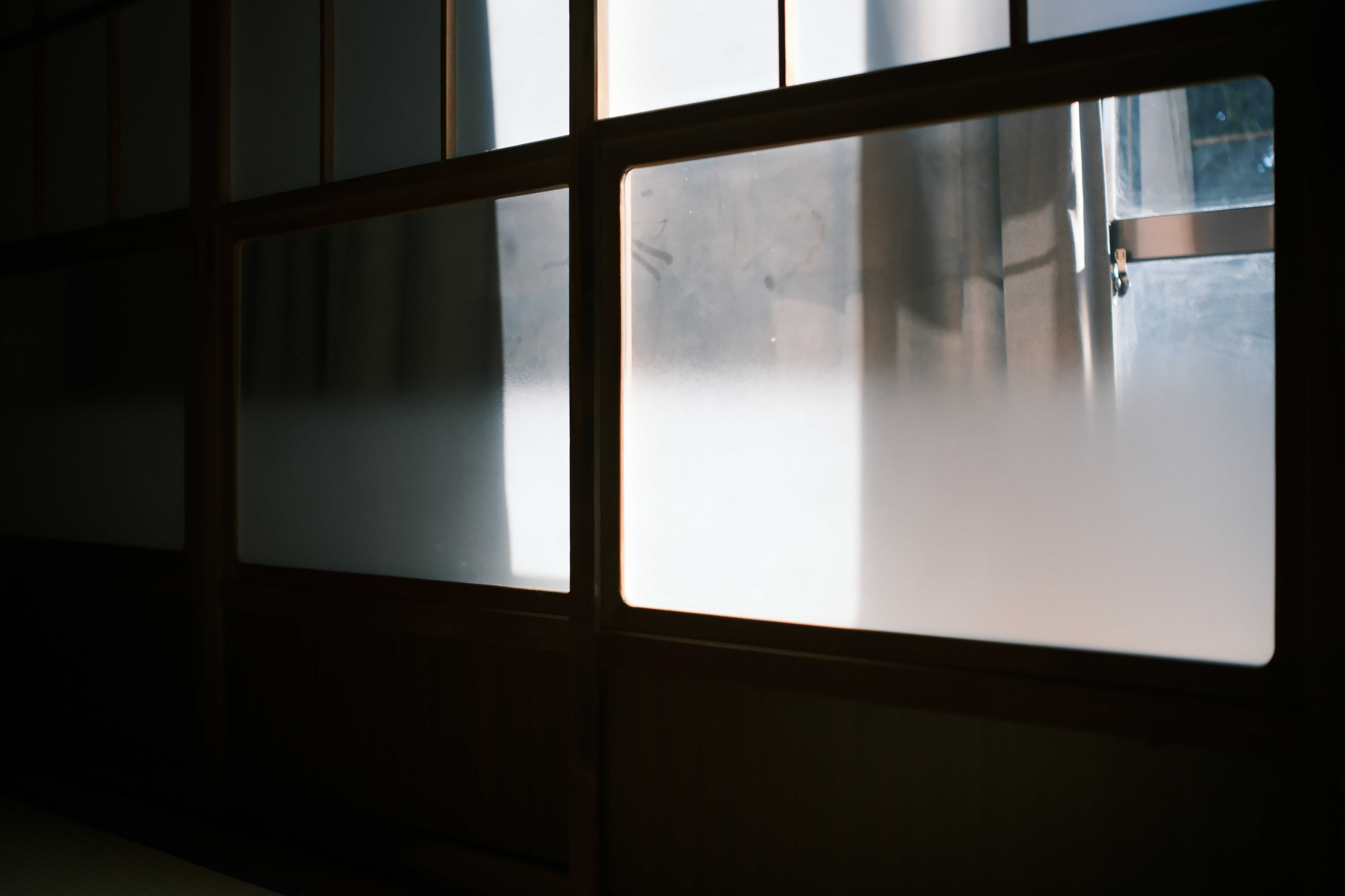 Condensation on a window in a Japanese apartment, person looking distressed