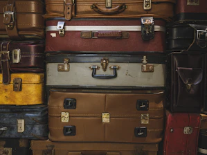 Stack of vintage suitcases in various colors and sizes