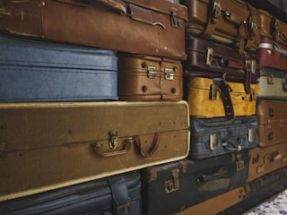 Stack of vintage suitcases in various colors and sizes