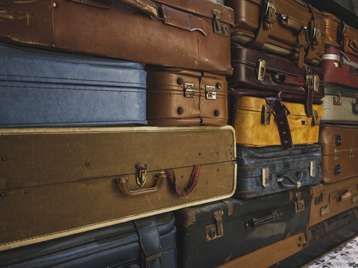 Stack of vintage suitcases in various colors and sizes