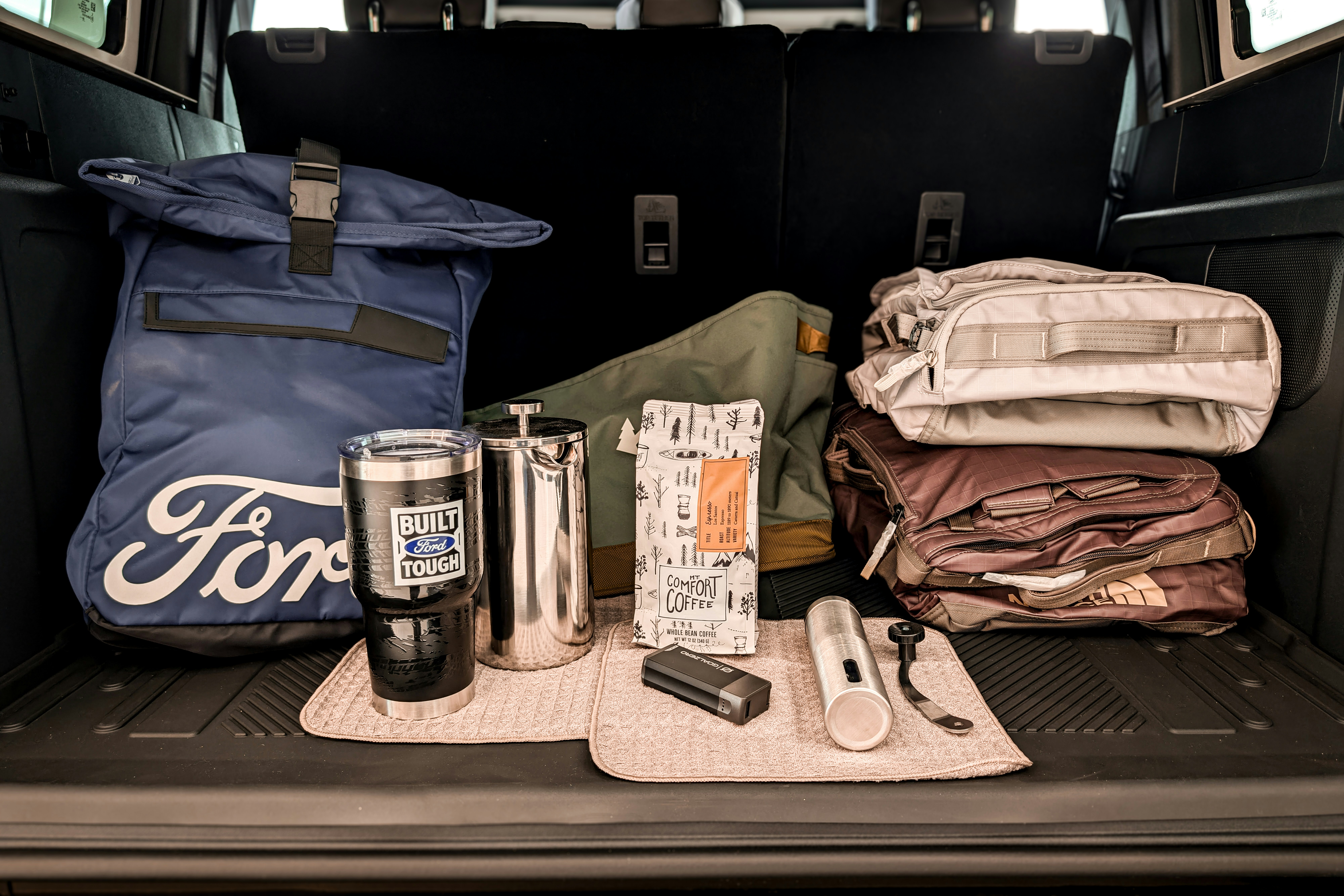 Ford branded bag and travel accessories in car trunk
