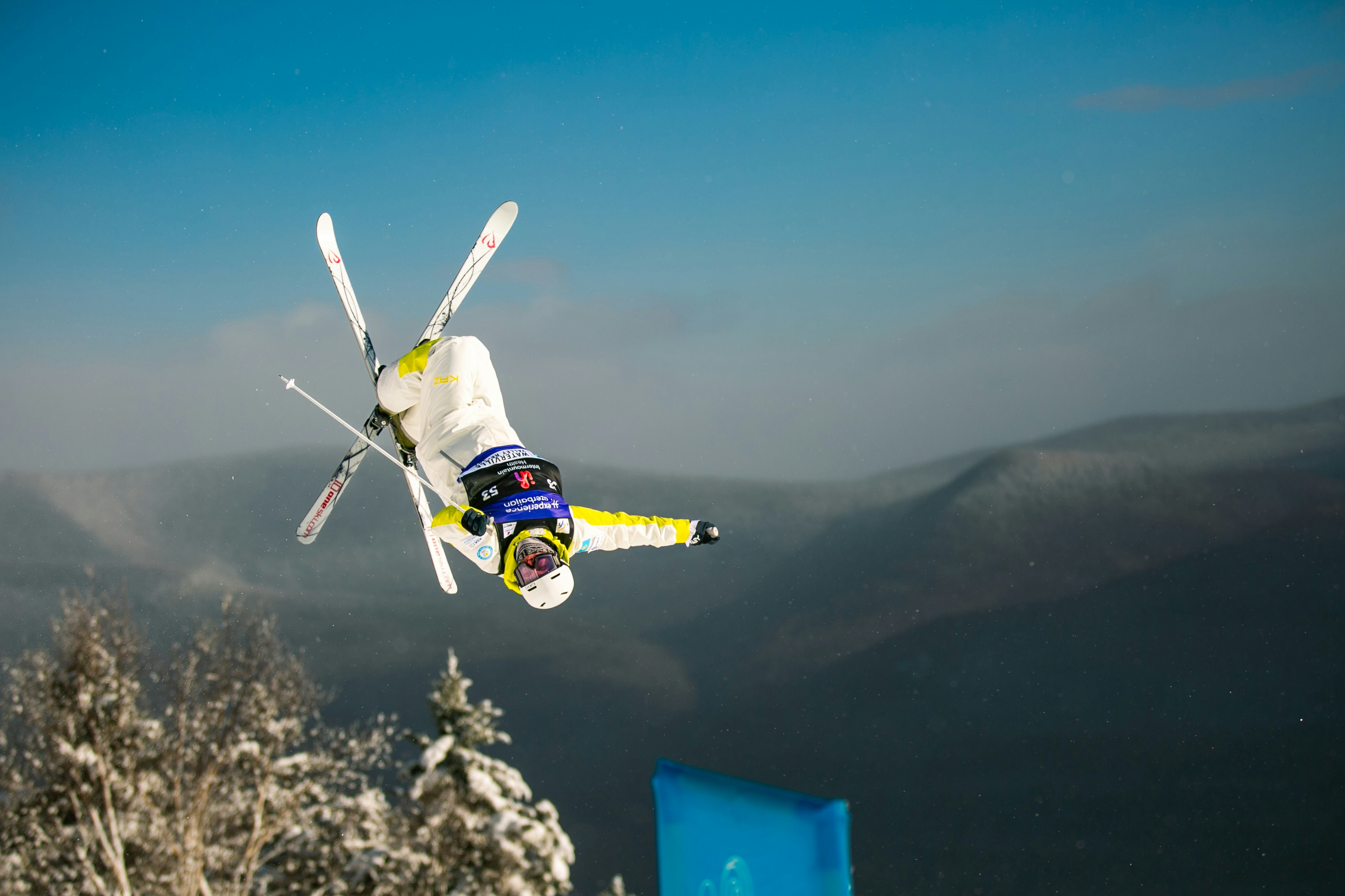 A skier performs a flip in the air.