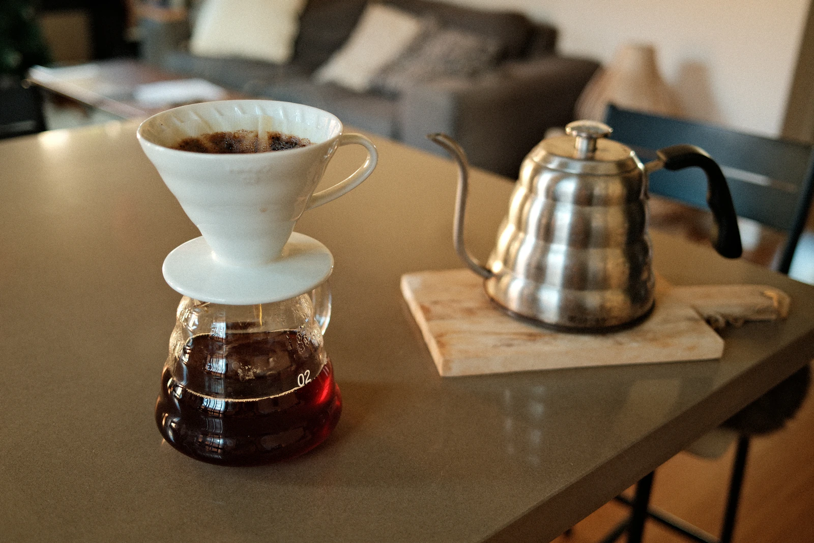 Real coffee brewing setup with a kettle and coffee maker on a kitchen table