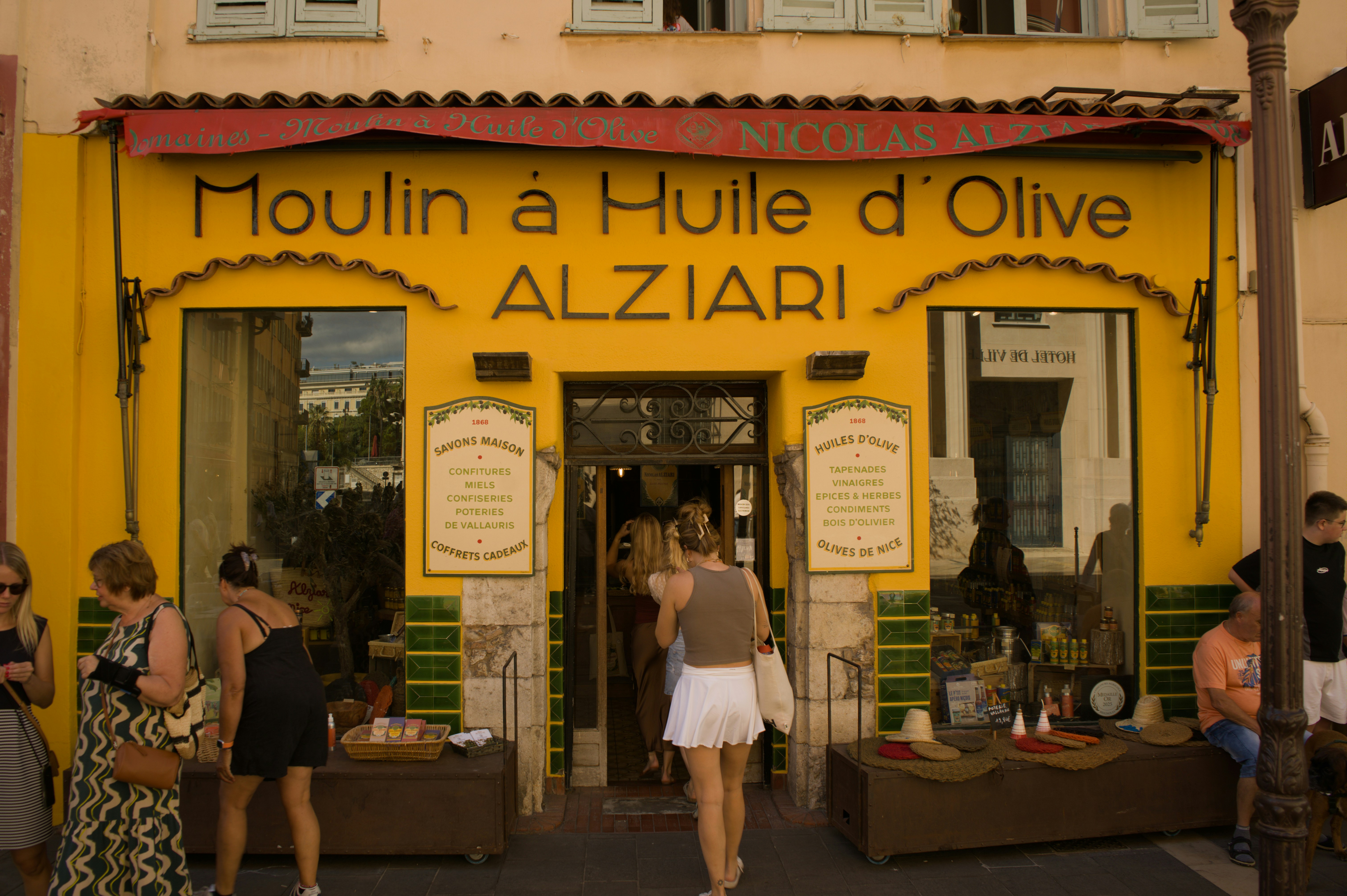 Yellow storefront of moulin a huile d'olive alziari.
