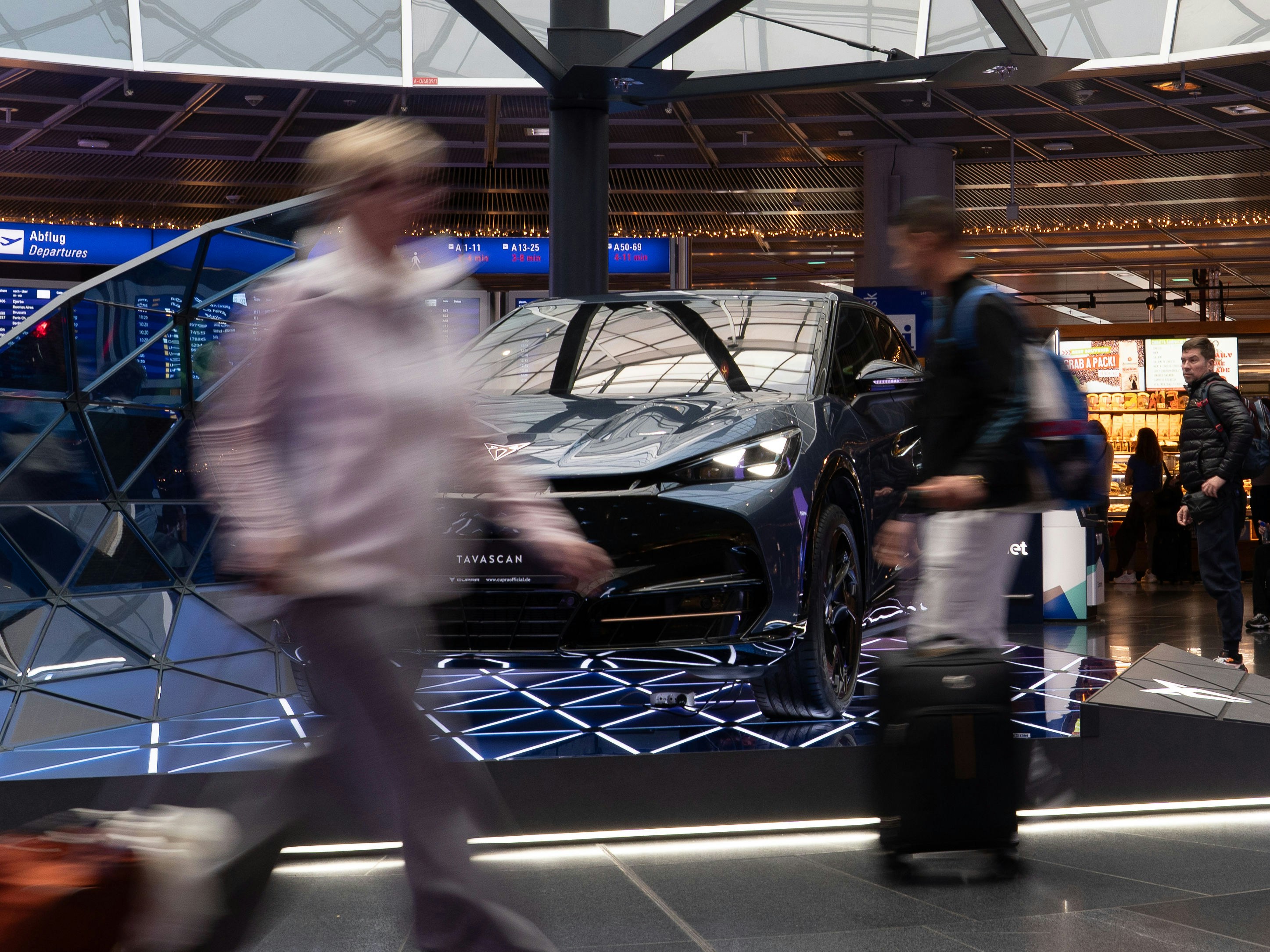 Traveler checking airport departure board using advanced flight booking techniques