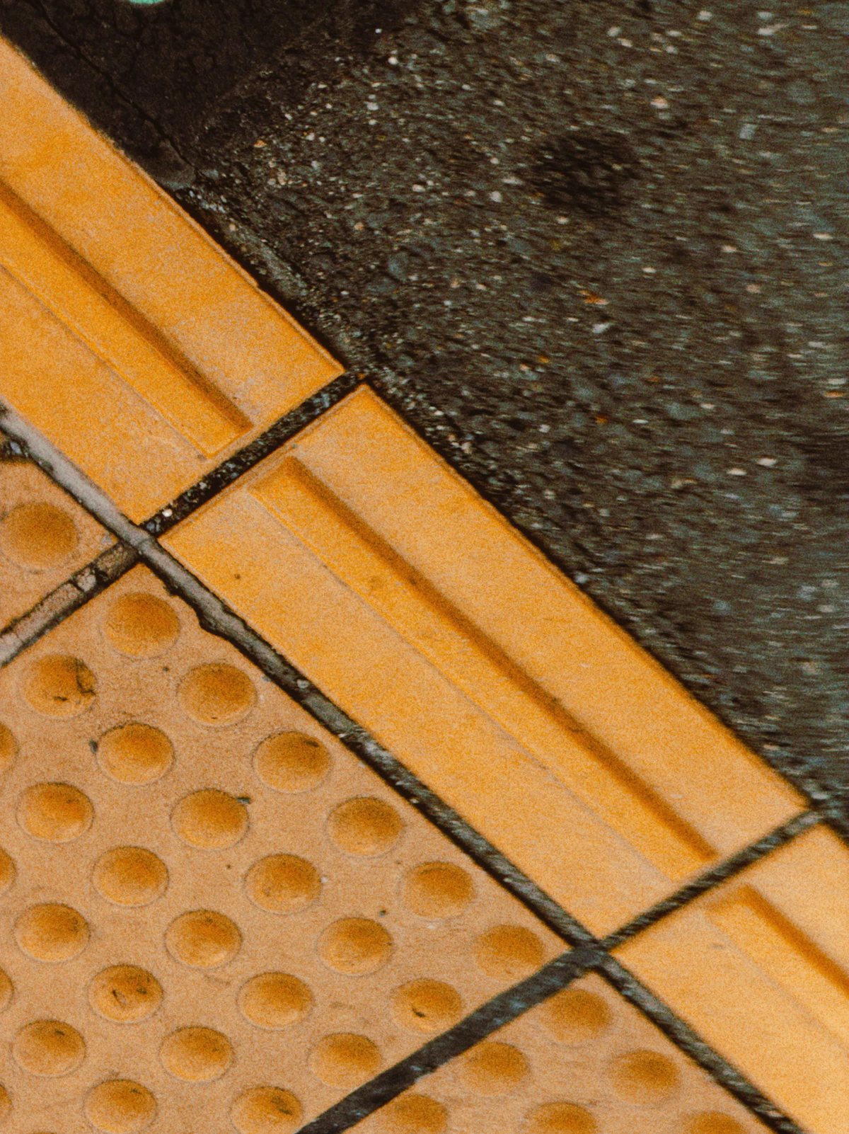 Close-up of tactile paving surface texture that needs periodic maintenance to protect colour contrast