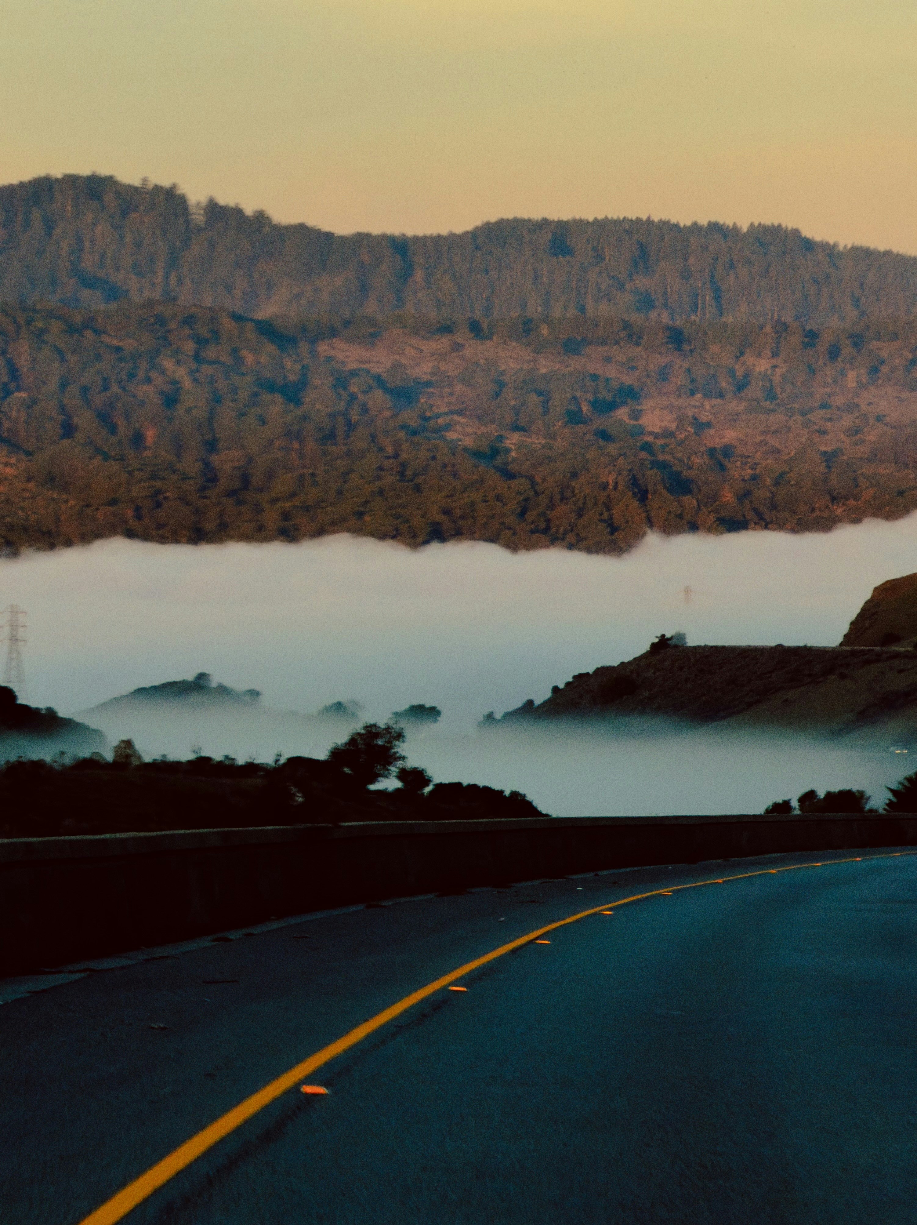 Foggy valley with a road and distant mountains