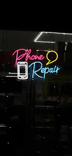 Neon sign for phone repair with phone and speech bubble.