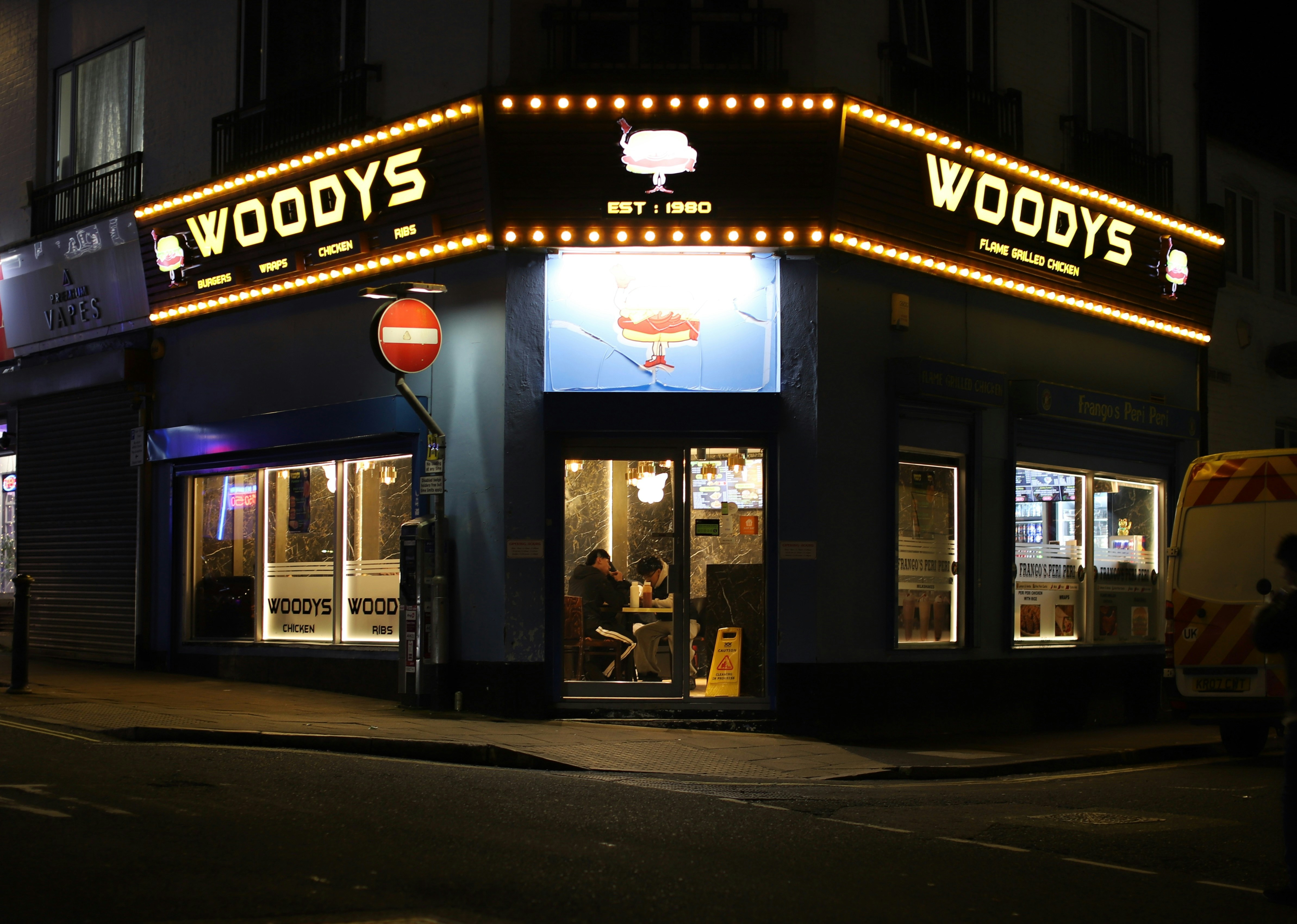 Woodys restaurant at night with illuminated sign