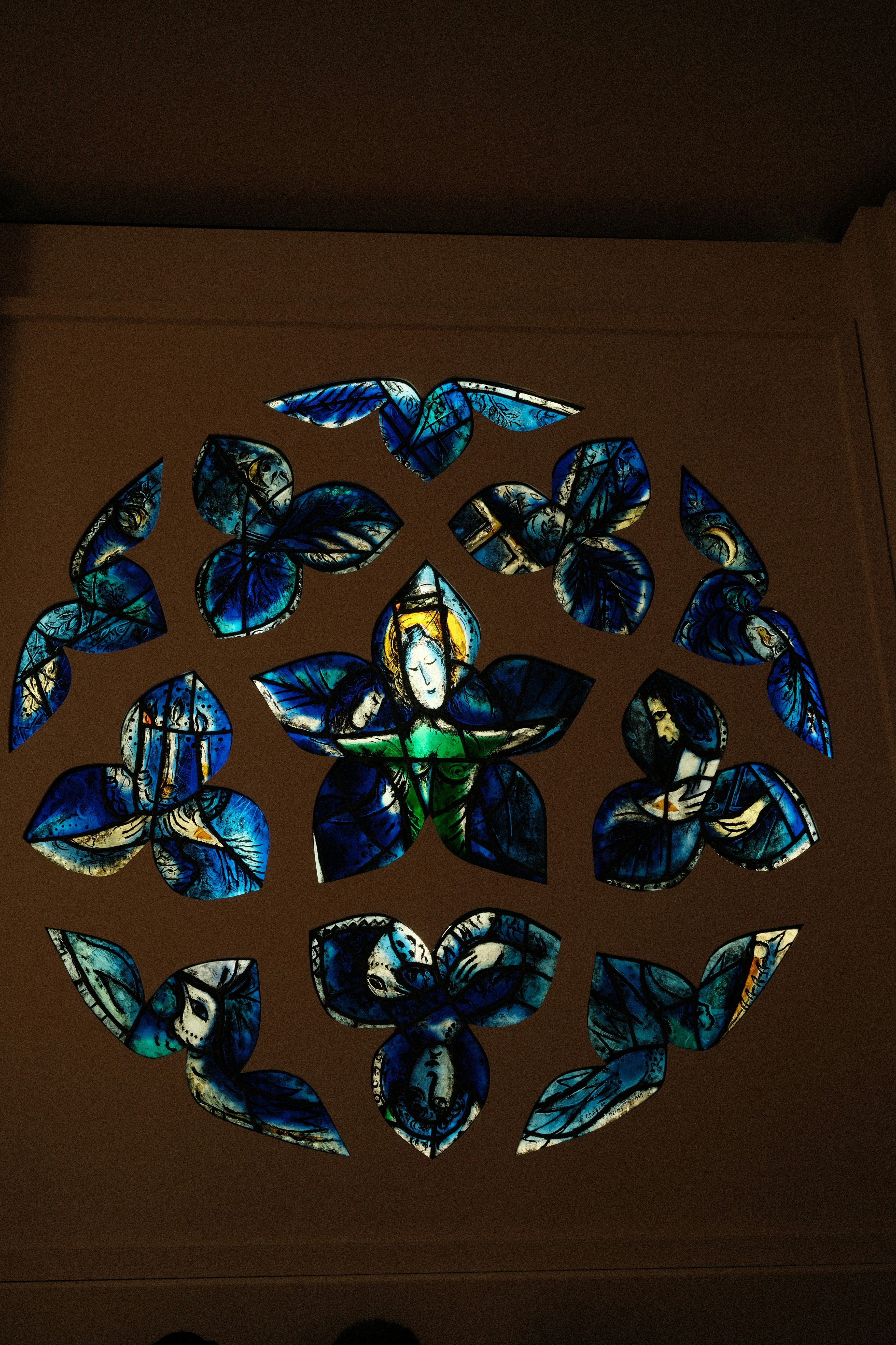 Circular stained glass window with blue floral design