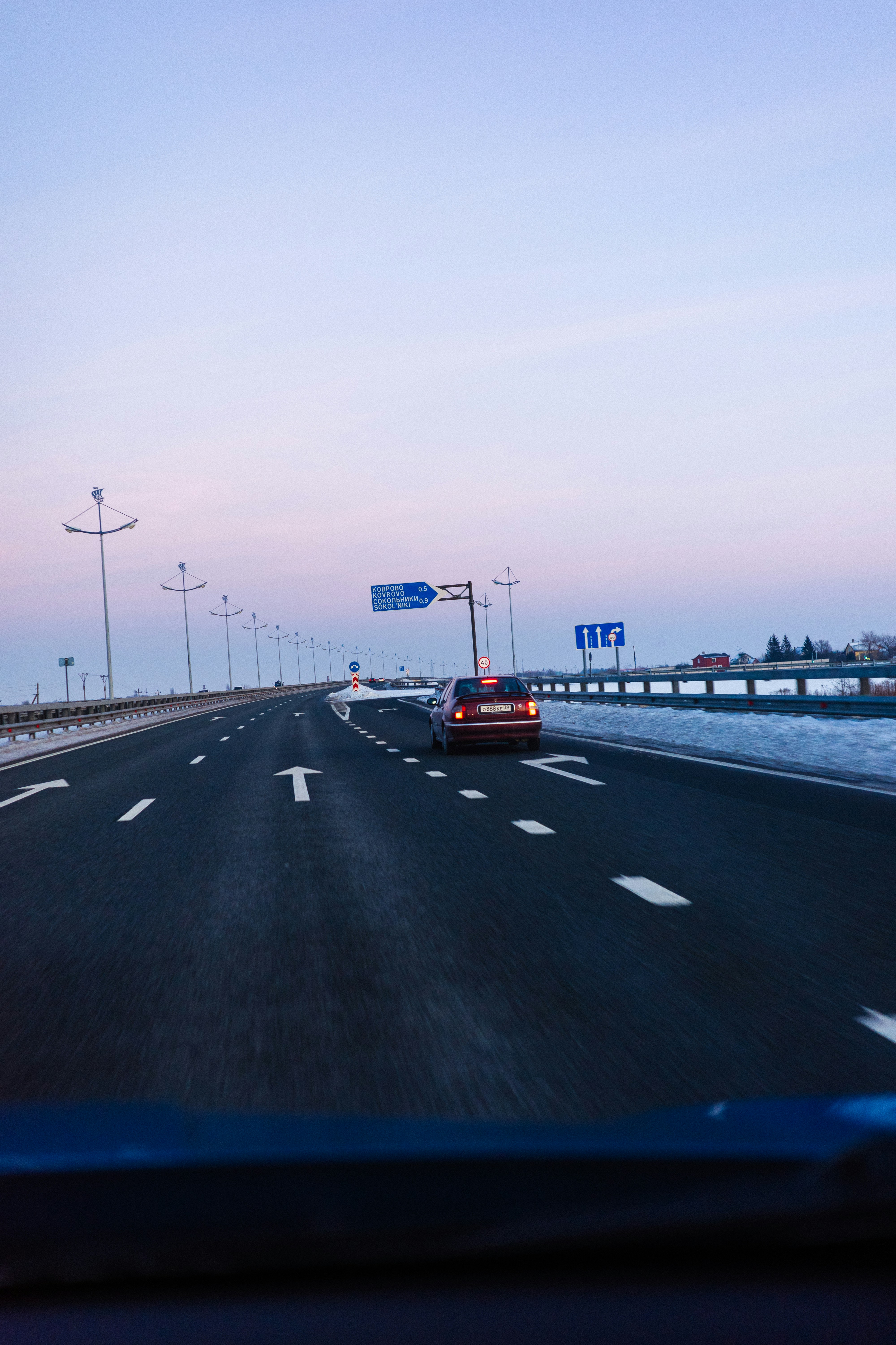 Car driving on a highway at dusk