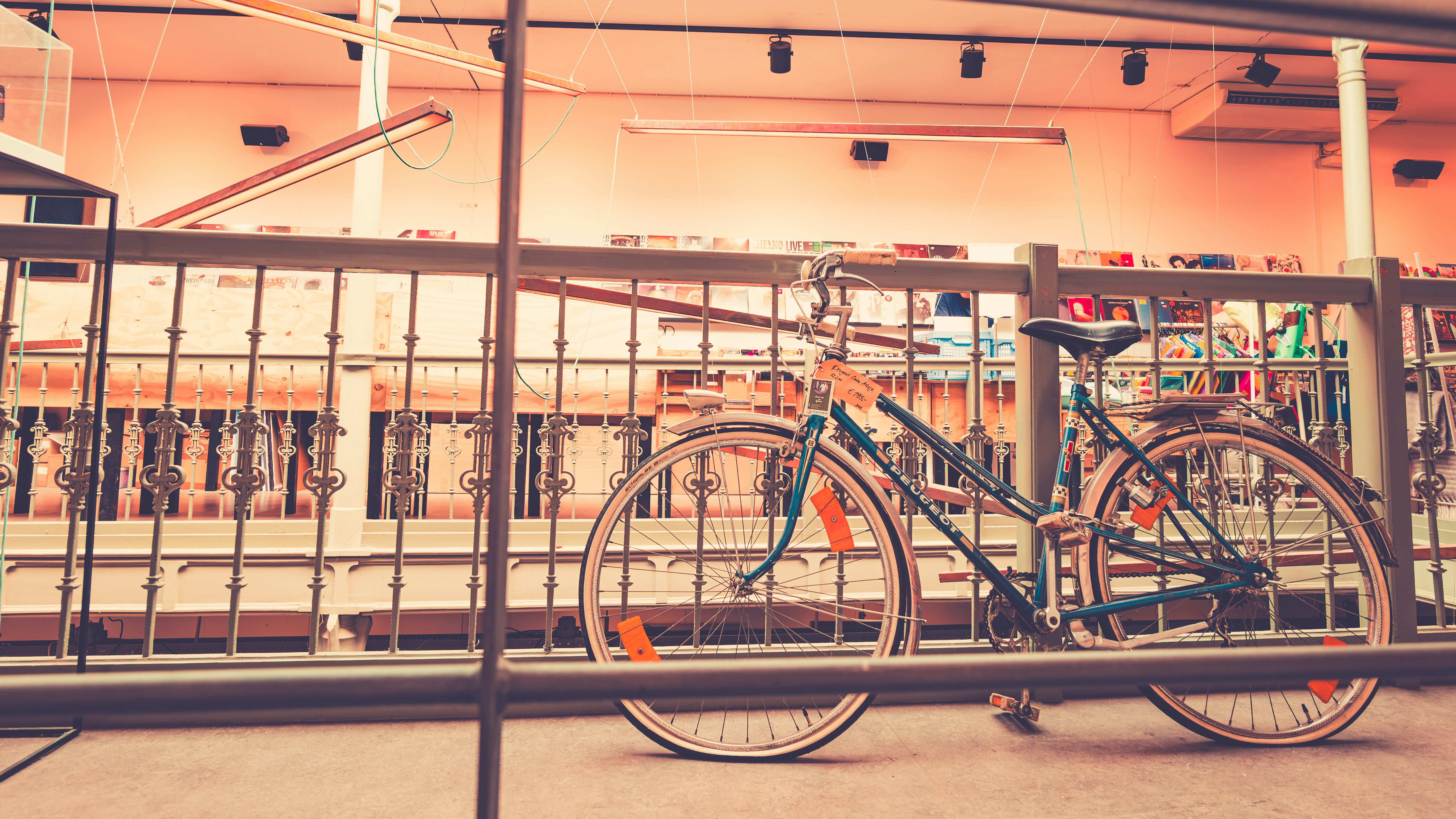 Vintage bicycle parked indoors with shelves in background