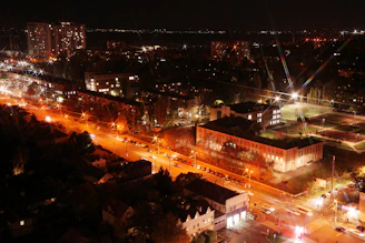 Aerial view of a city at night with glowing lights.