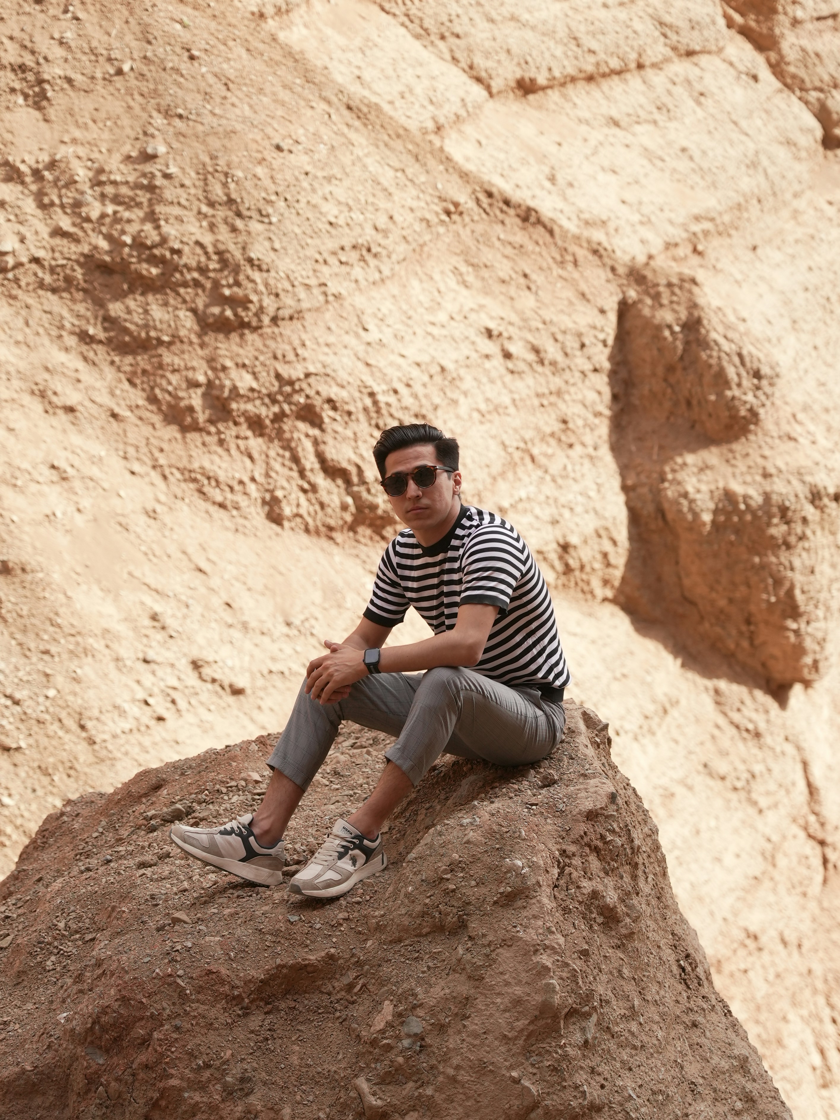 Man sitting on a rock in a desert canyon