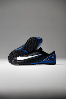 Black soccer cleats with white and blue accents