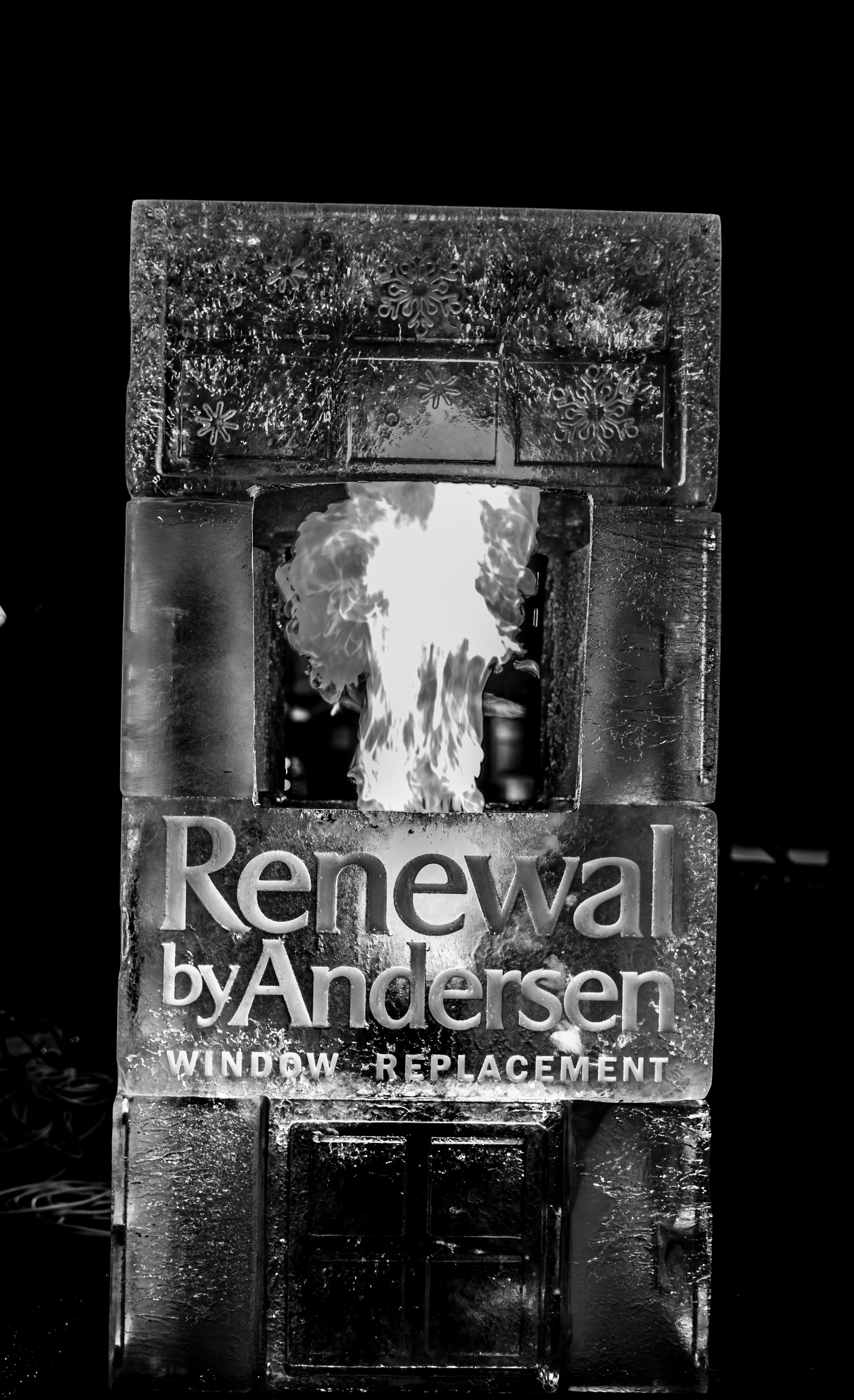 Ice sculpture featuring fire and renewal by andersen logo.