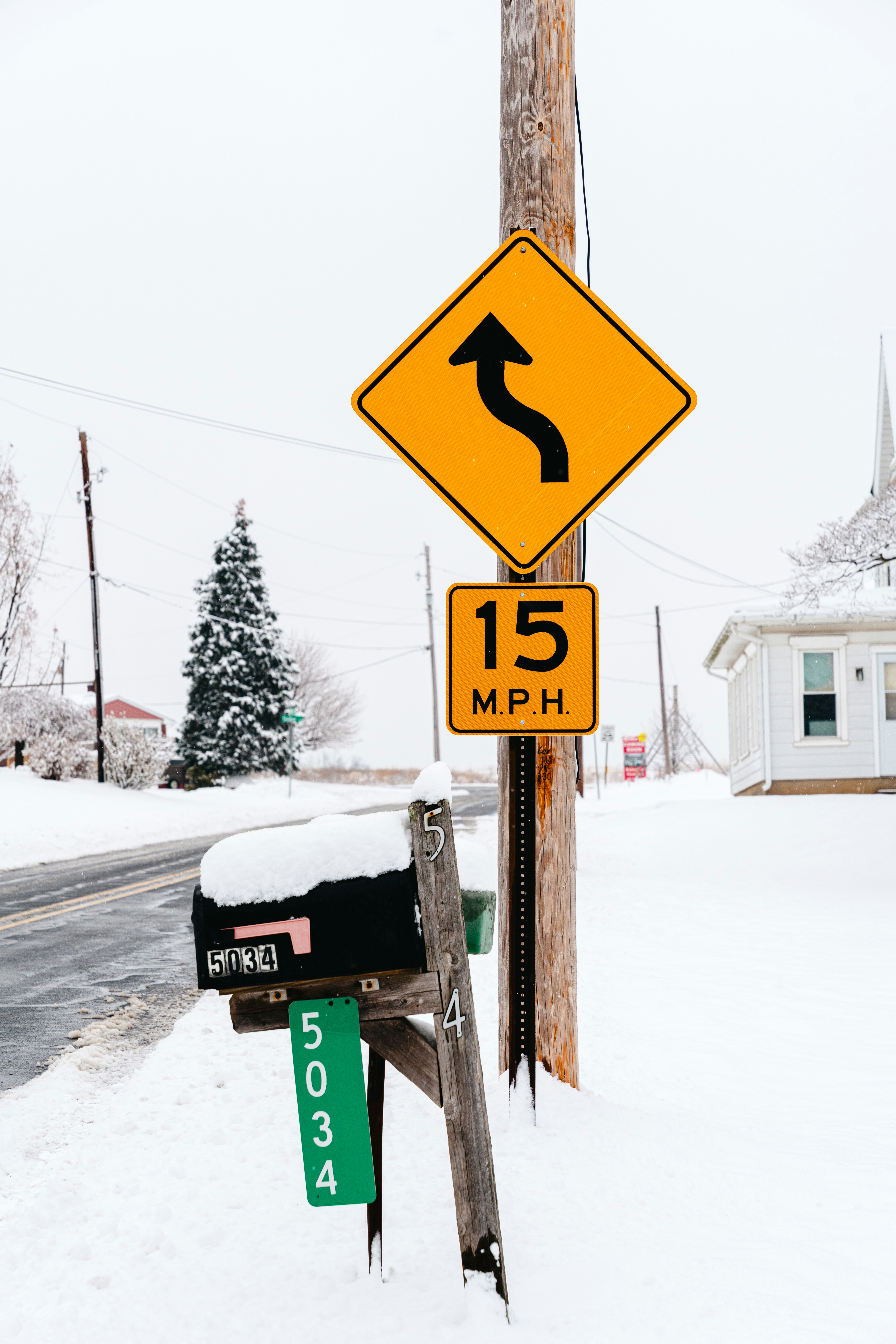 Road signs and mailbox in snowy weather