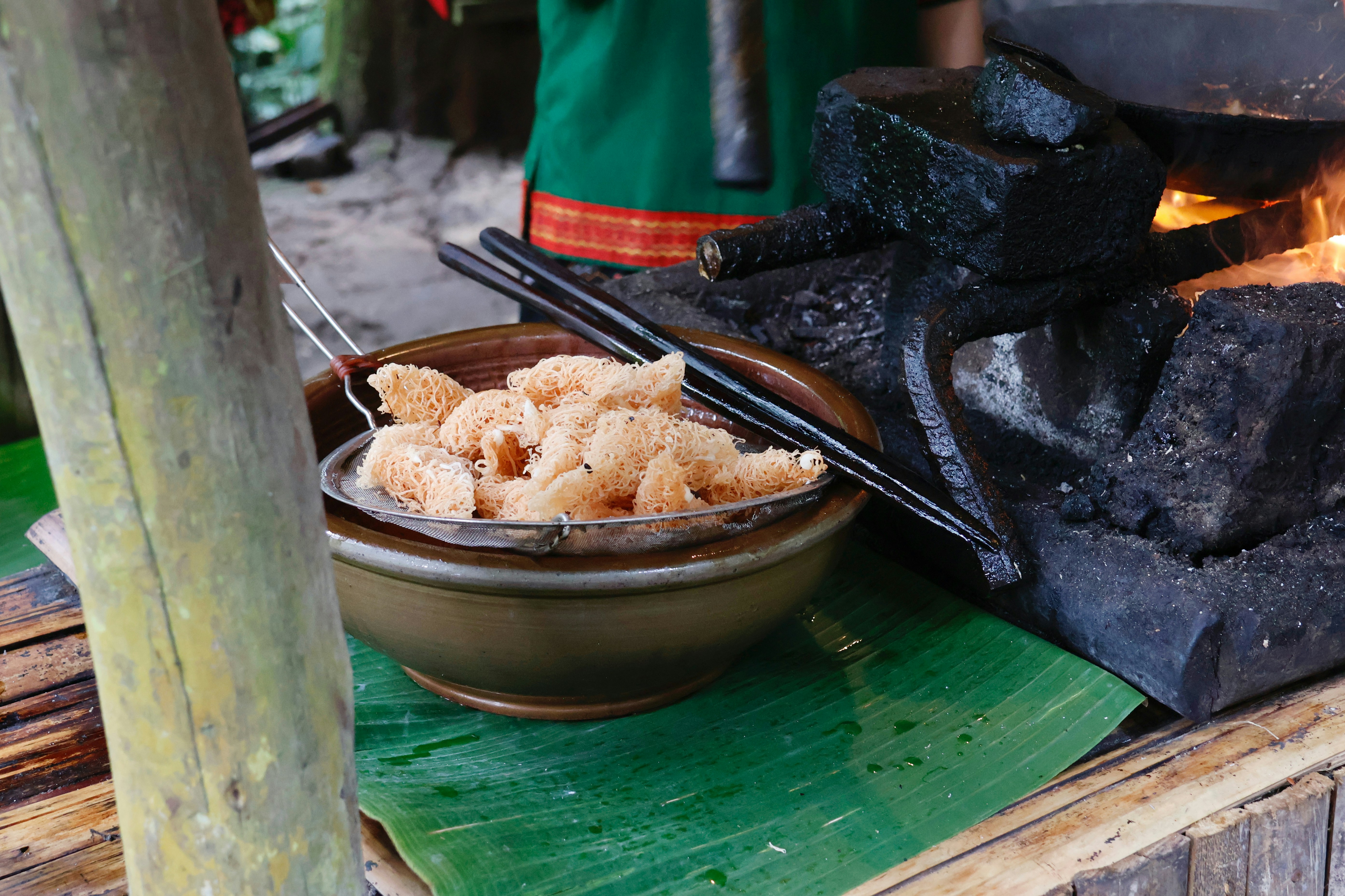 Fried snacks being drained in a bowl