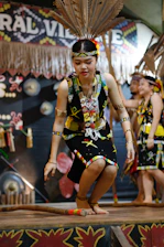 Young woman in traditional attire performs a cultural dance.
