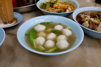 Bowl of fish ball soup with vegetables
