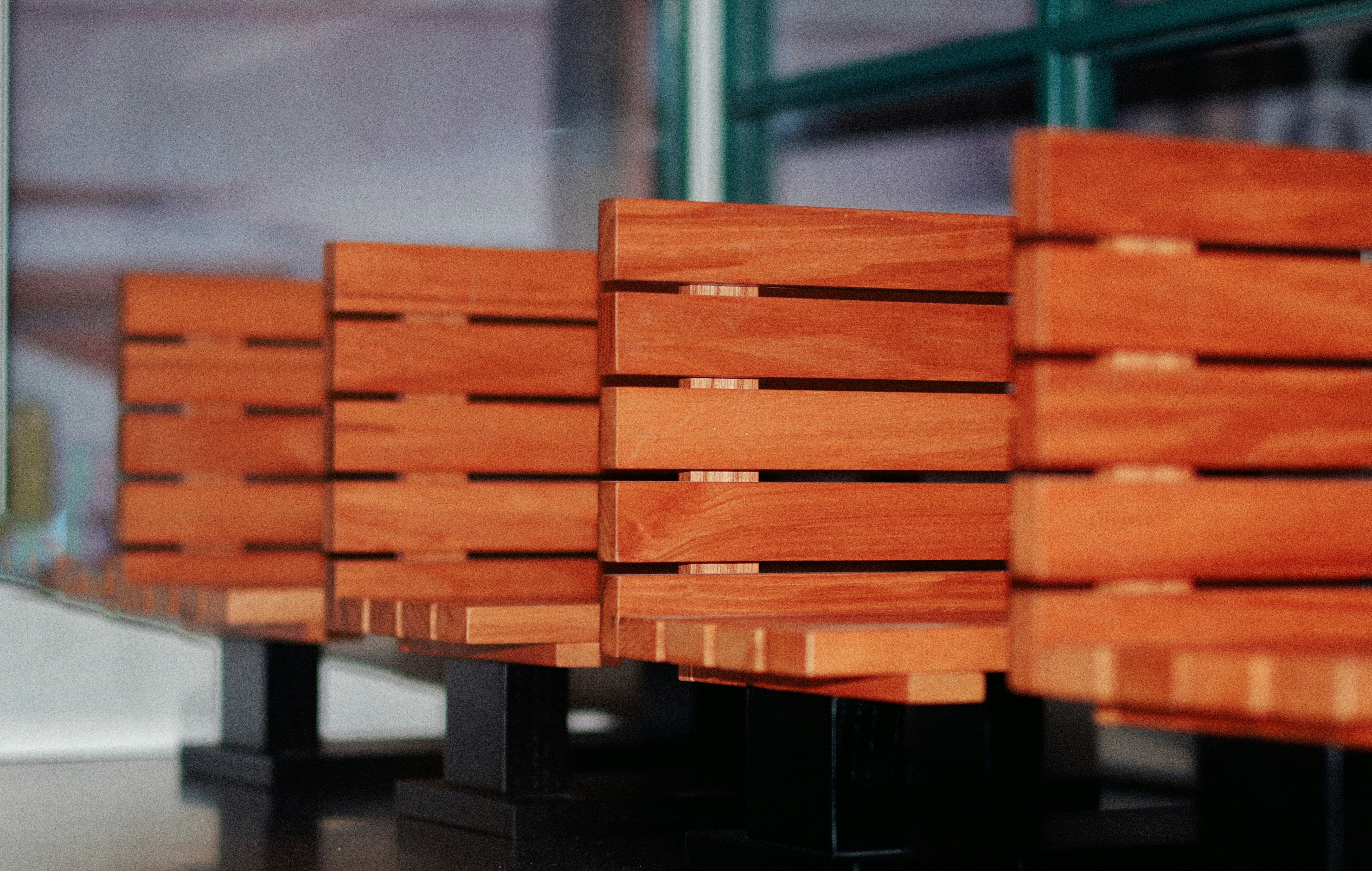 Row of empty wooden benches in a waiting area