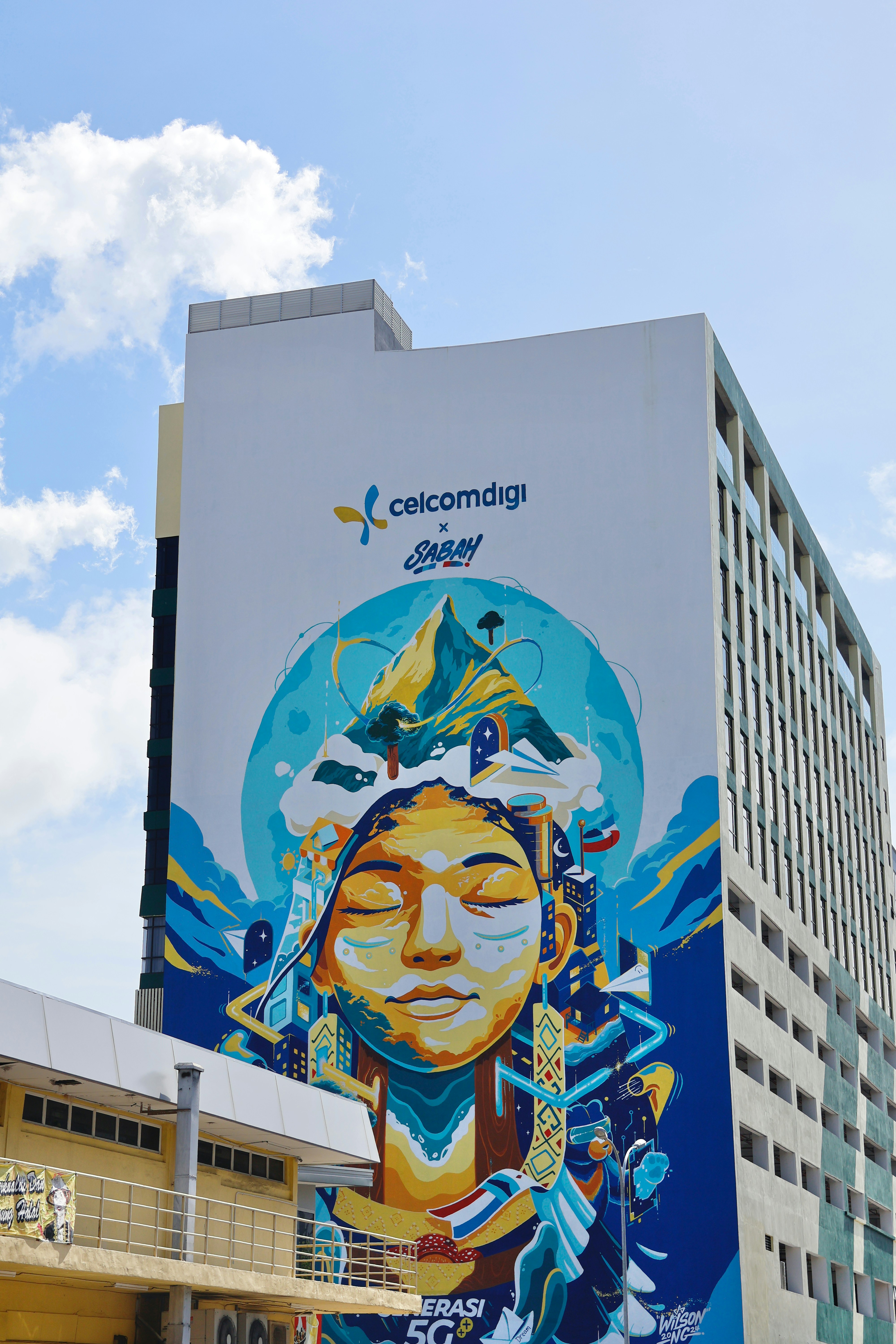 A large mural of a woman's face on a building.
