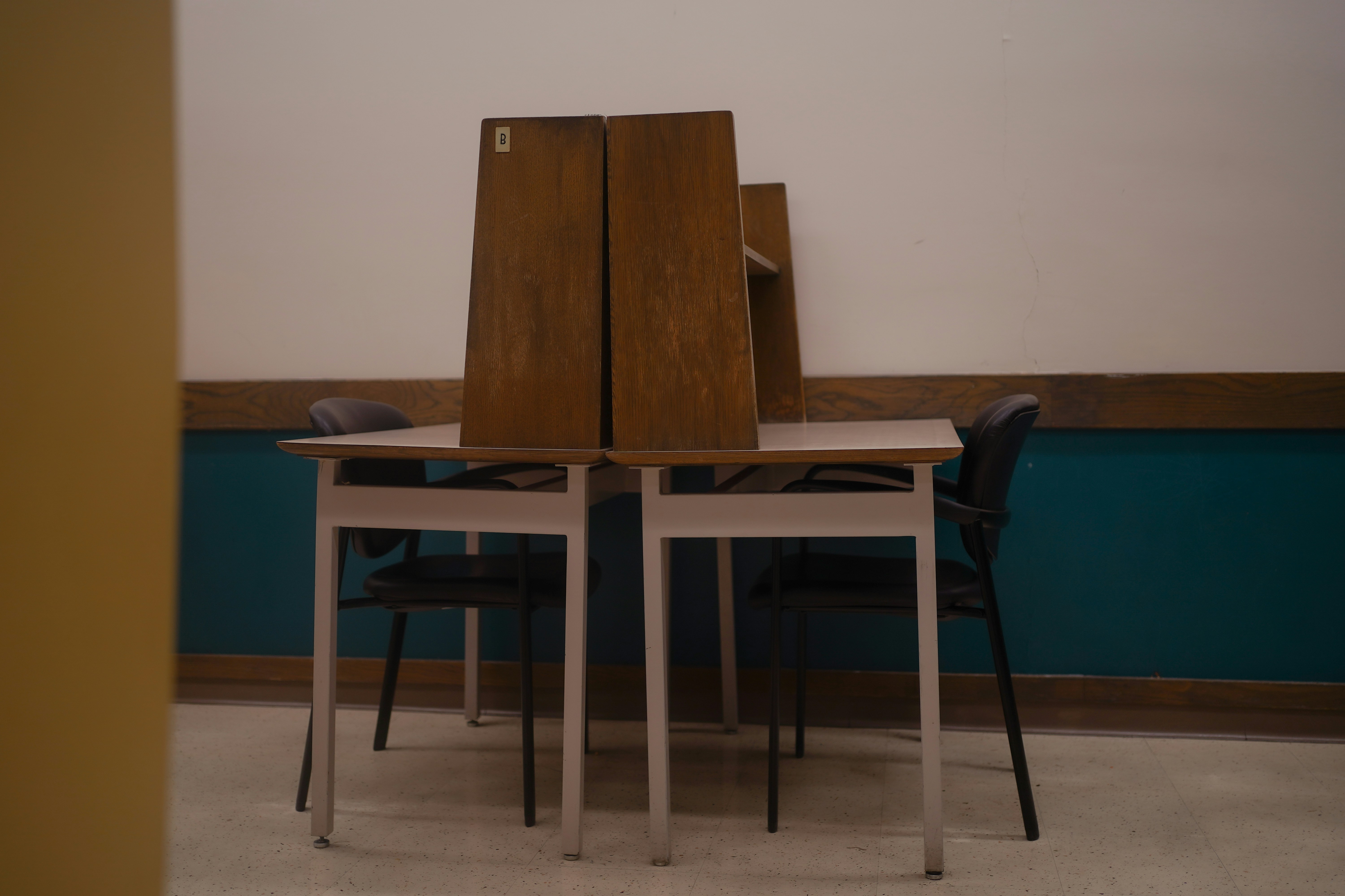 A classroom full of students, some looking at textbooks with questioning expressions, while others are in deep thought, representing the impact of curriculum changes.