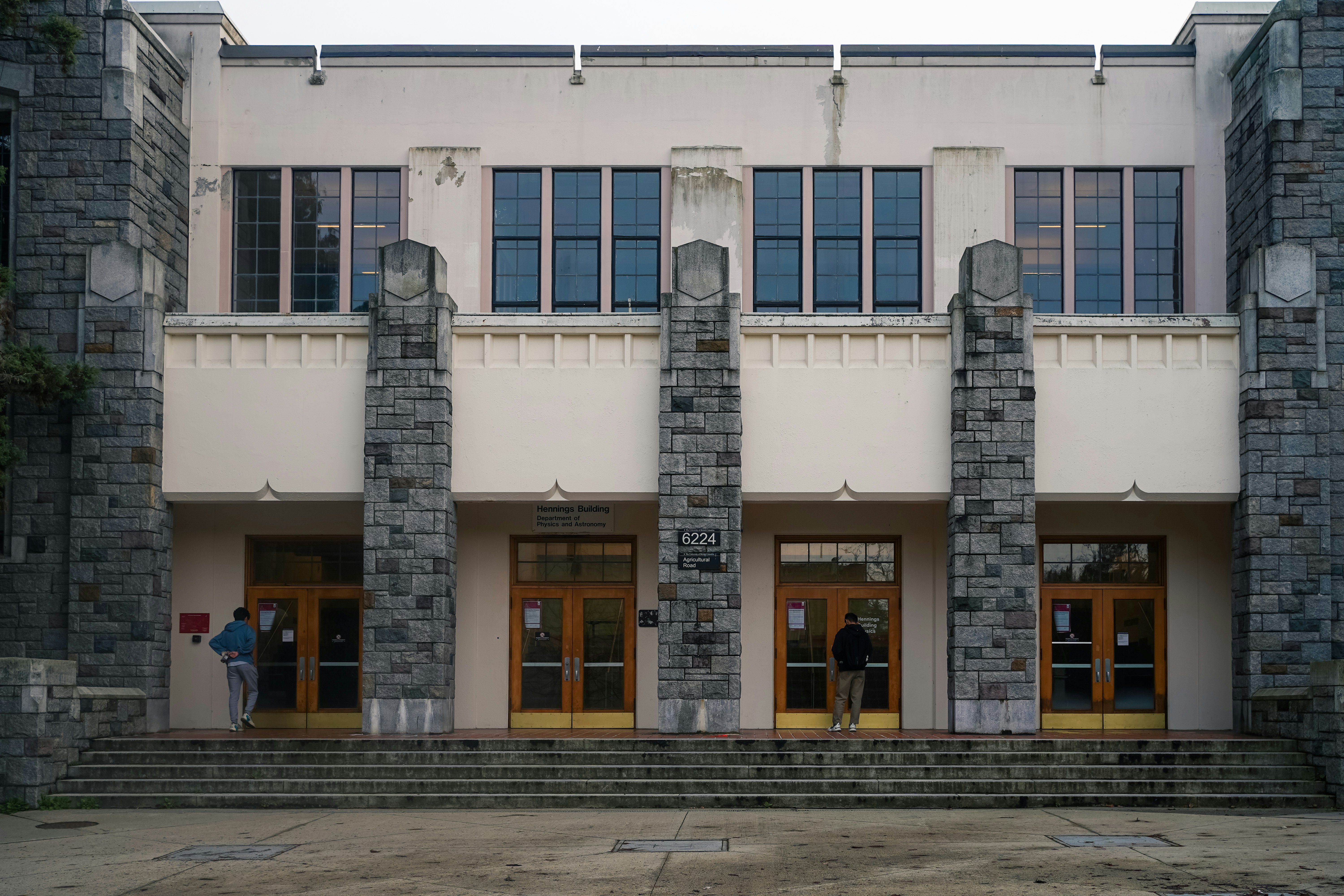 Grand stone building entrance with multiple doors and windows