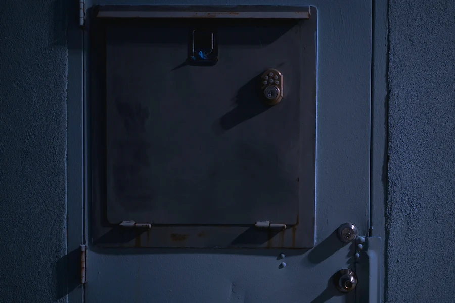 A closed metal door with a heavy lock, painted blue-grey.