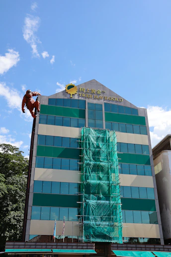 Man in orange suit scaling a building