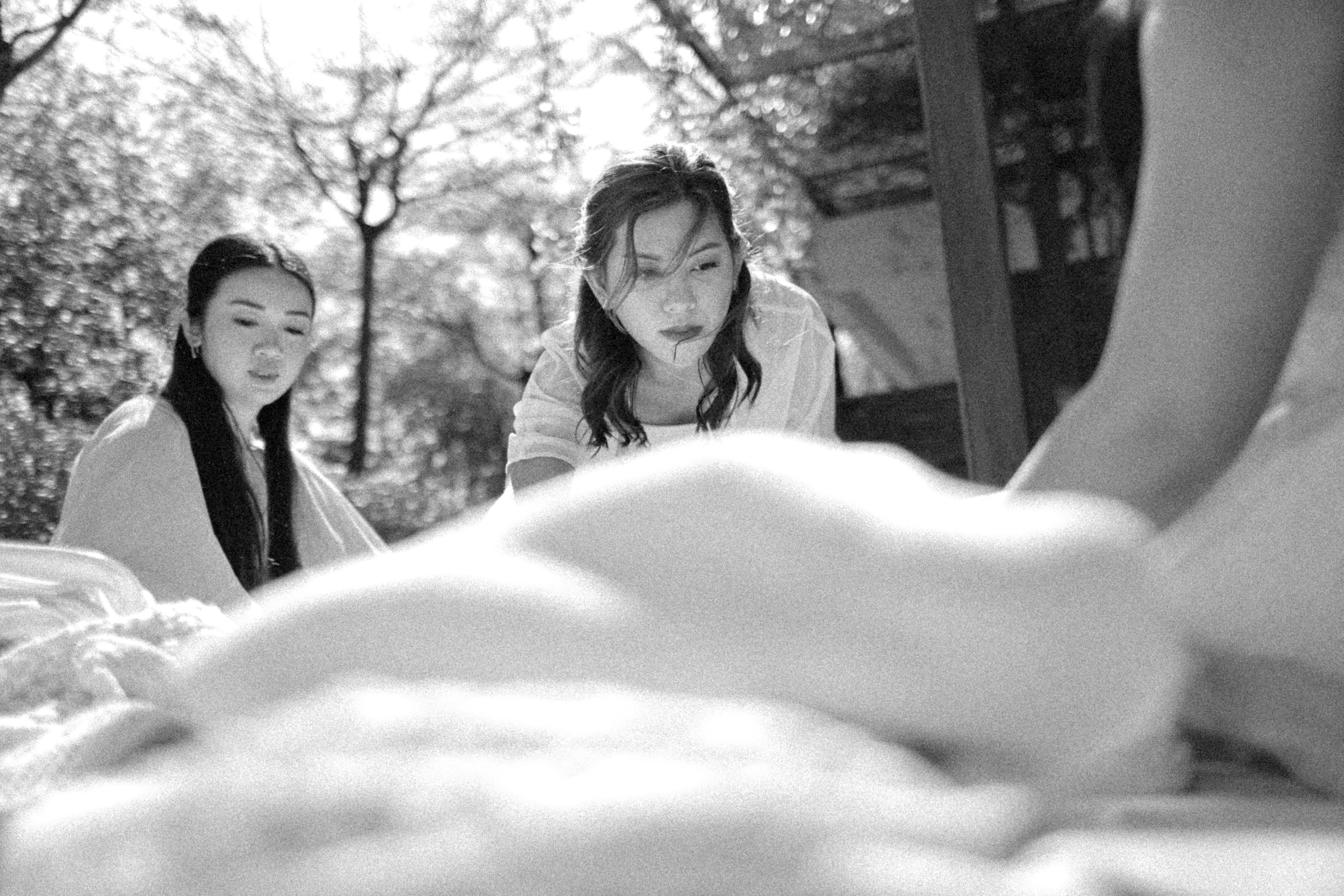 Two women looking at something in the foreground.