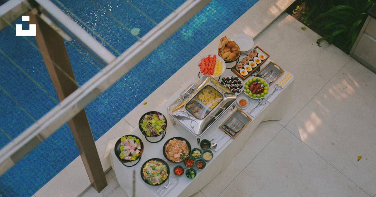 Buffet Style Pool Buffet table with assorted food dishes by the pool. photo – Free ...