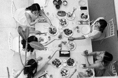 Four people enjoying a meal at a long table.