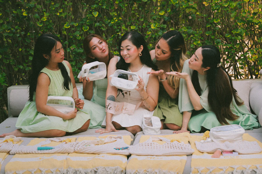 Five women holding breast pumps outdoors