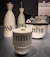 Vintage kitchen canisters labeled 'zimt', 'essig', and 'mehl'.