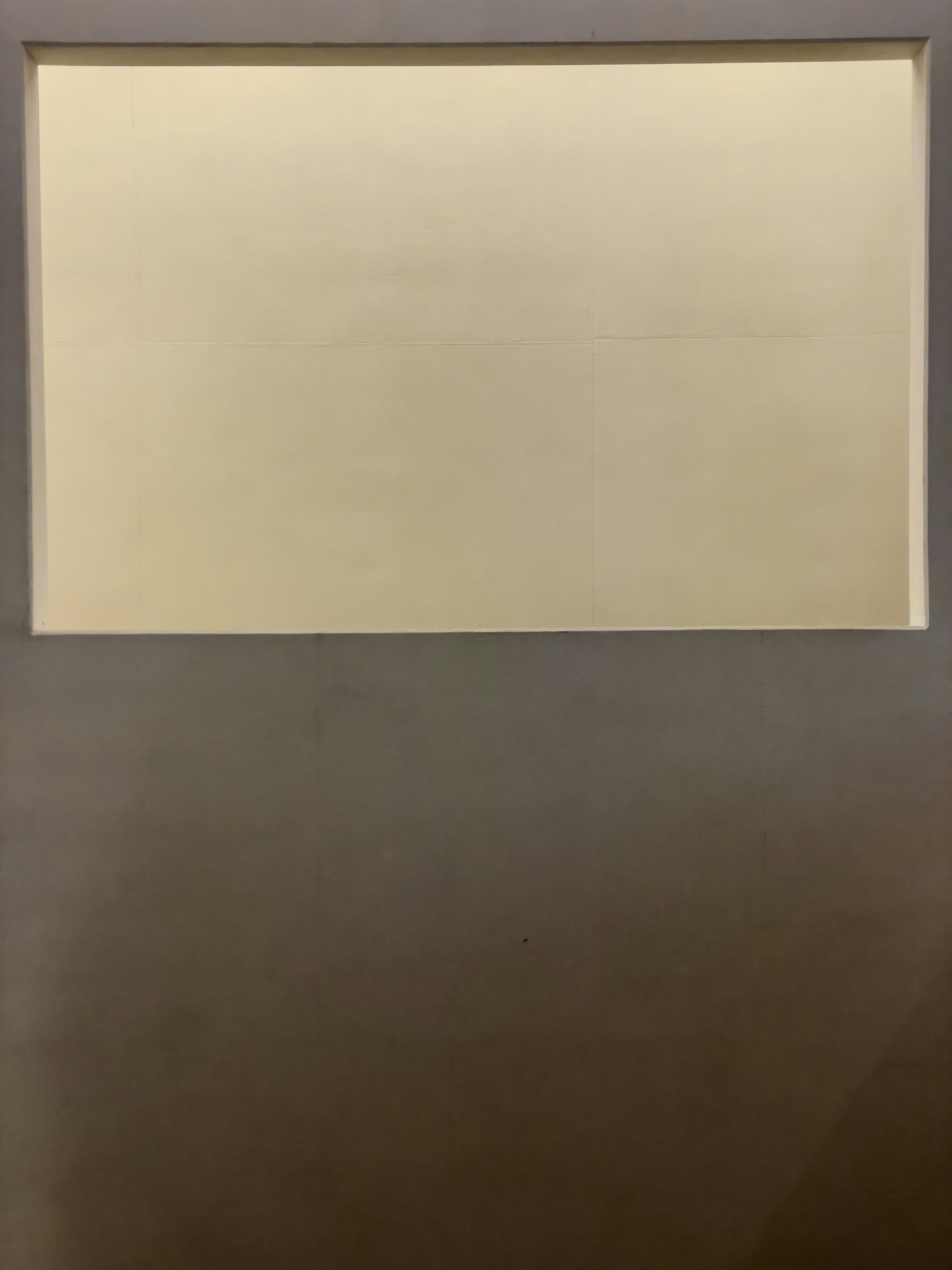 A light cream colored rectangle on a dark gray background