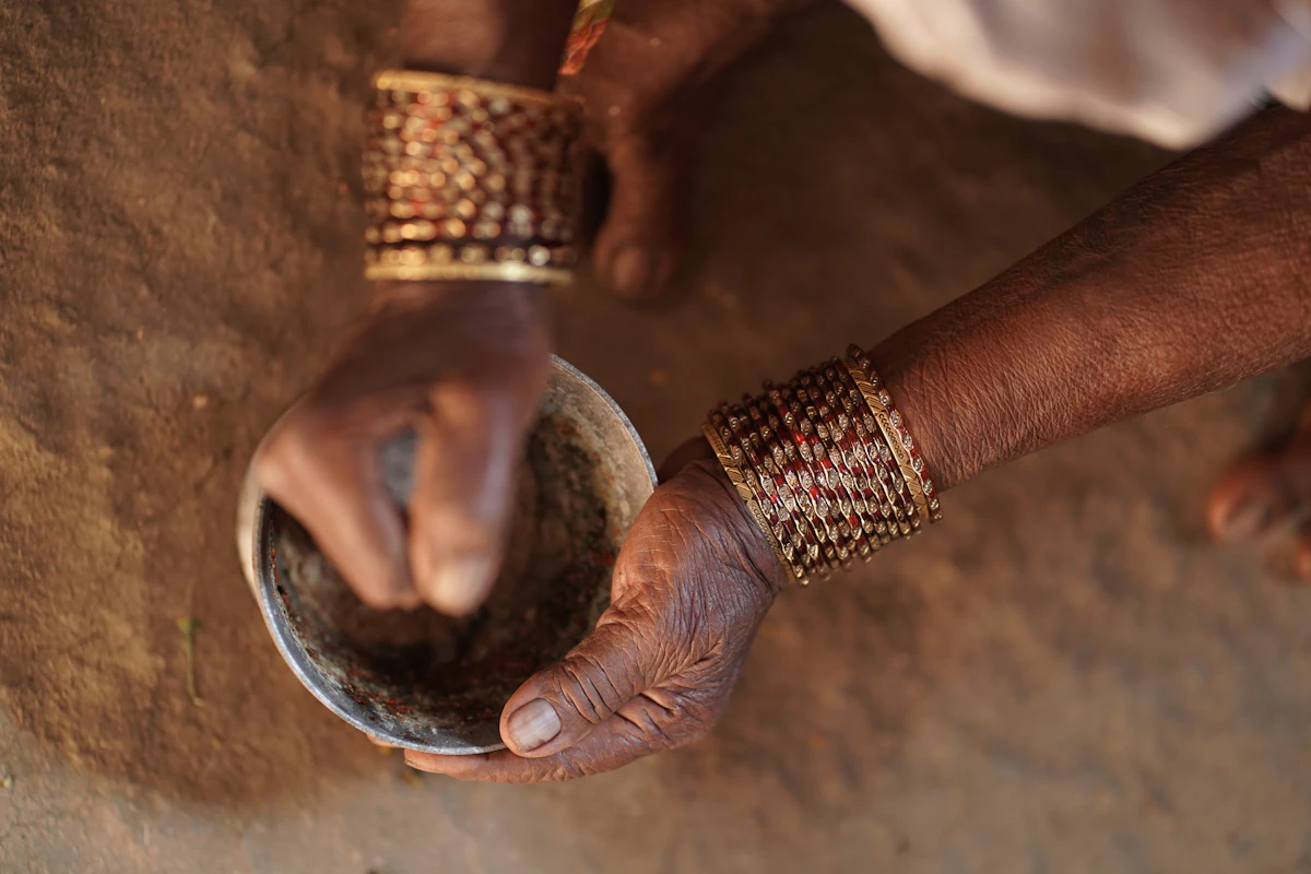 Whole spices being ground by hand