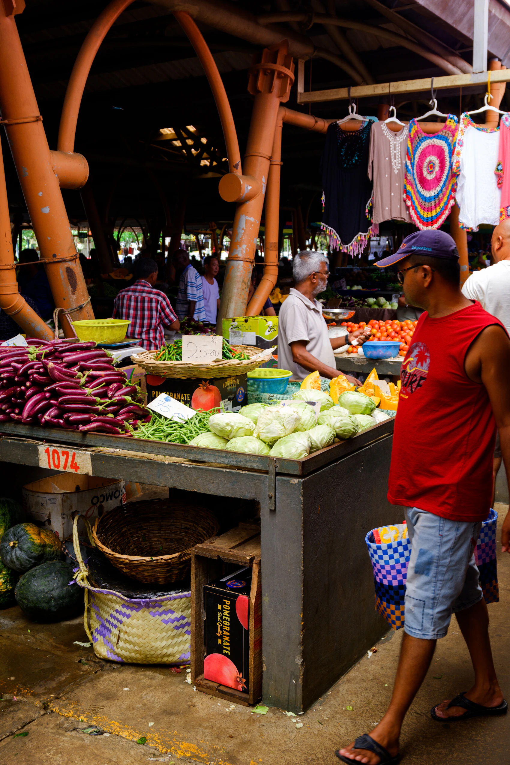Shoppers and traders among colourful produce at a market in Mauritius