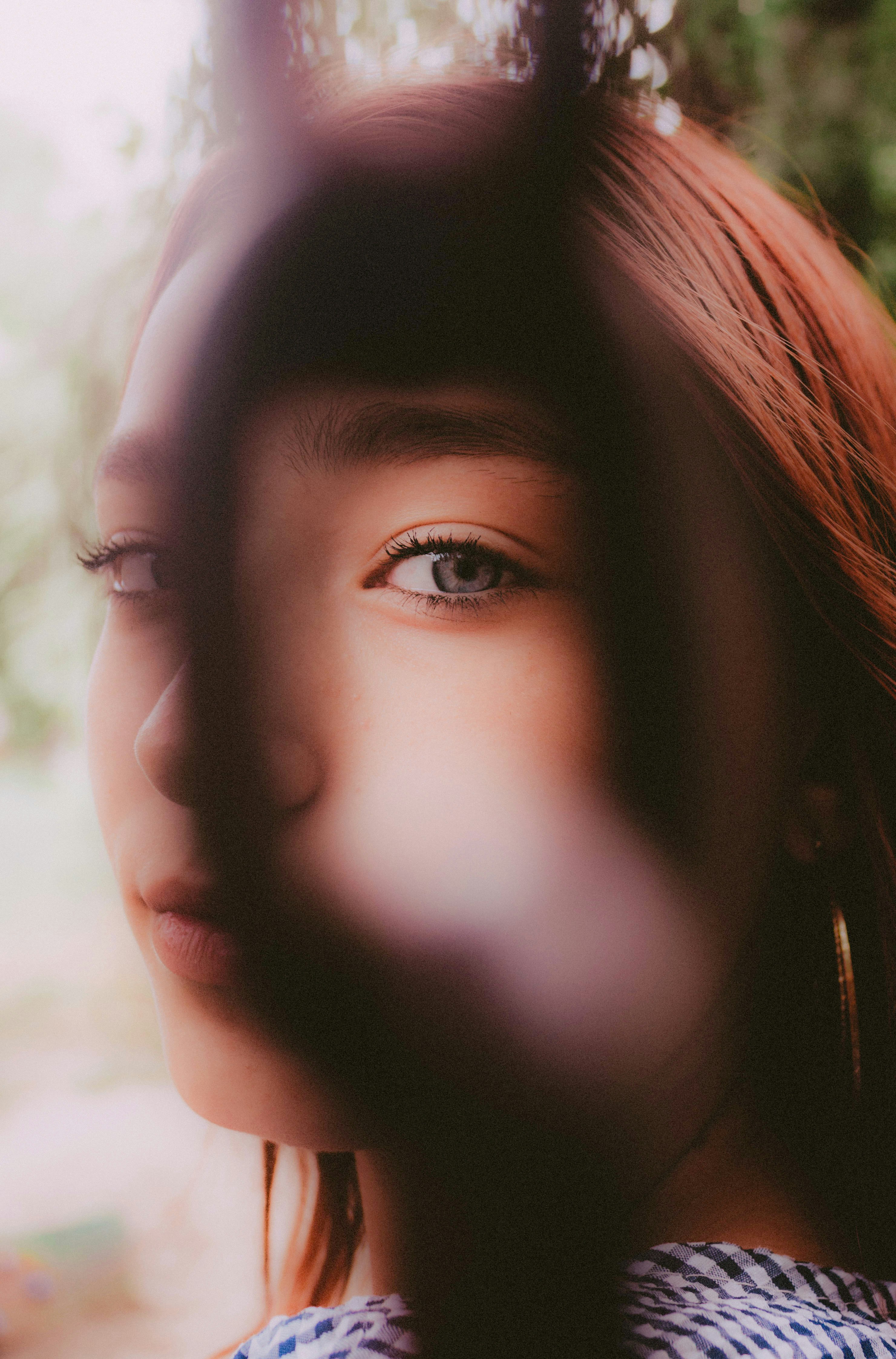 Close-up of a young woman's face with blue eyes