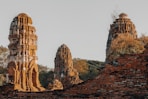 Ancient brick ruins with weathered stupas and greenery