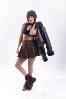 Woman in winter fashion with jacket over shoulder