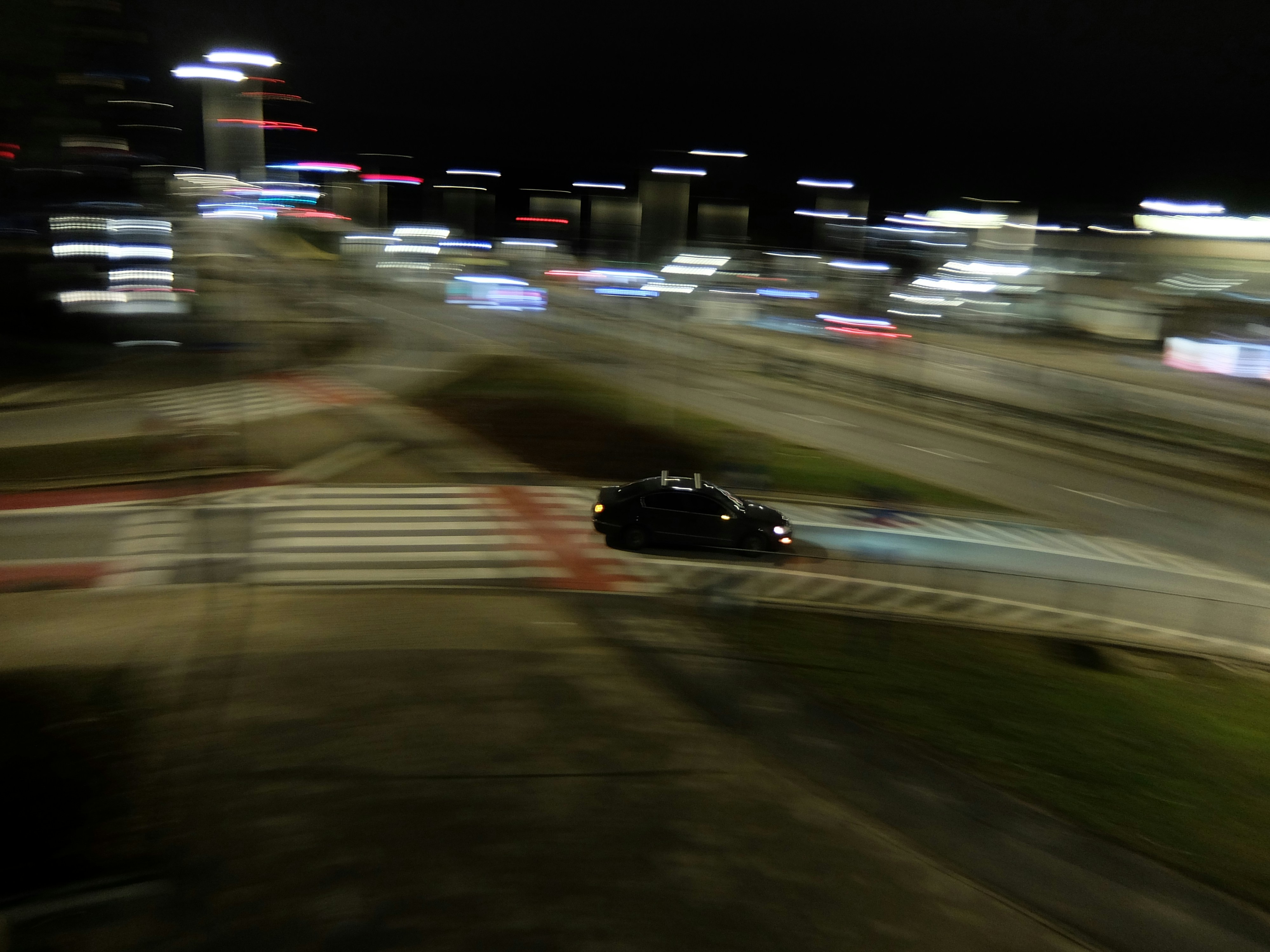 Car driving on a street at night with motion blur