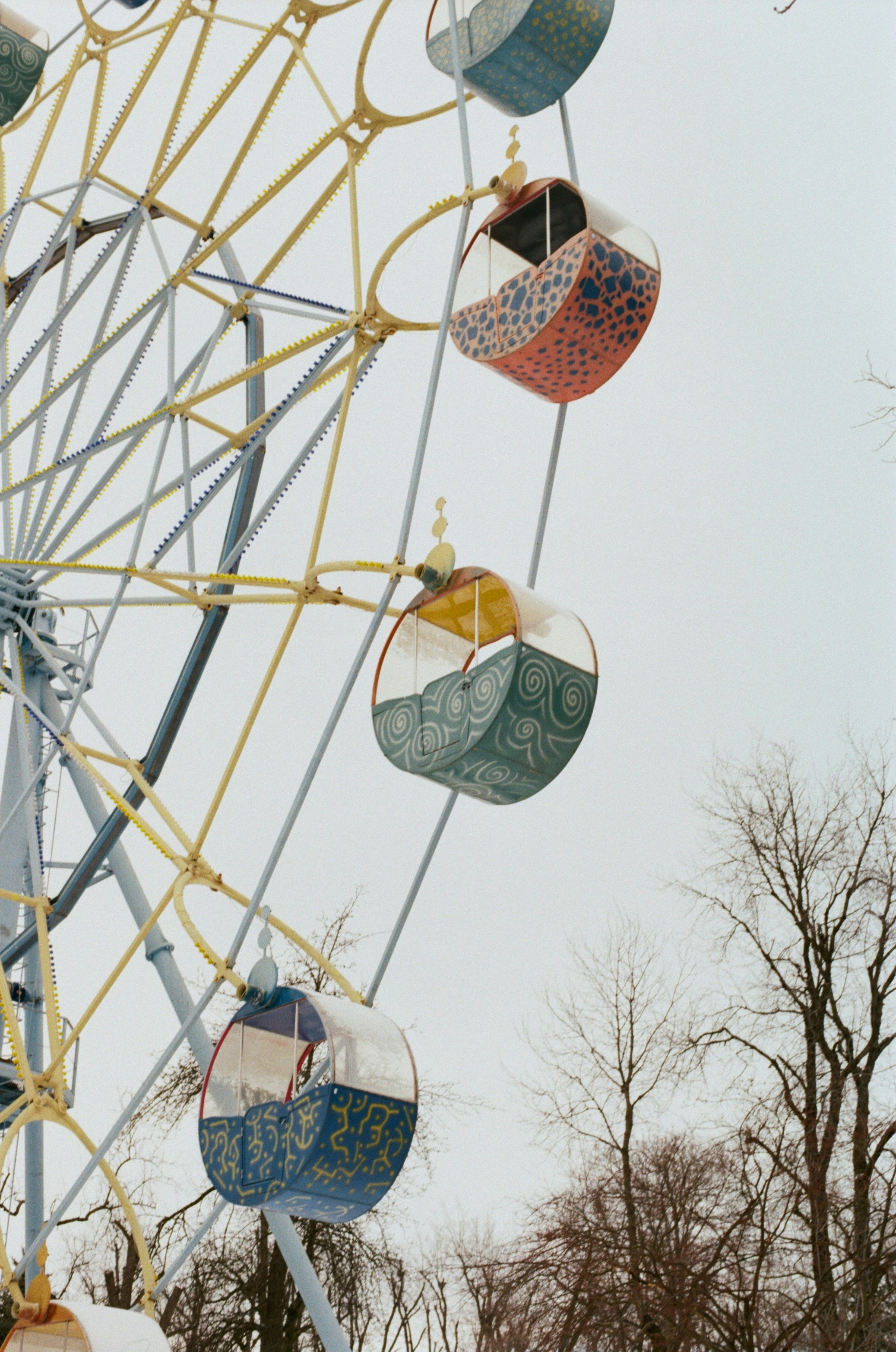 Ferris wheel cabins against a pale sky