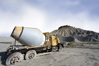Old cement truck abandoned in a desolate landscape.