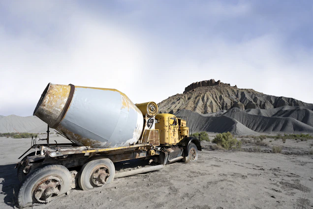 Old cement truck abandoned in a desolate landscape.