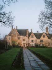 Stone manor house with a path and garden