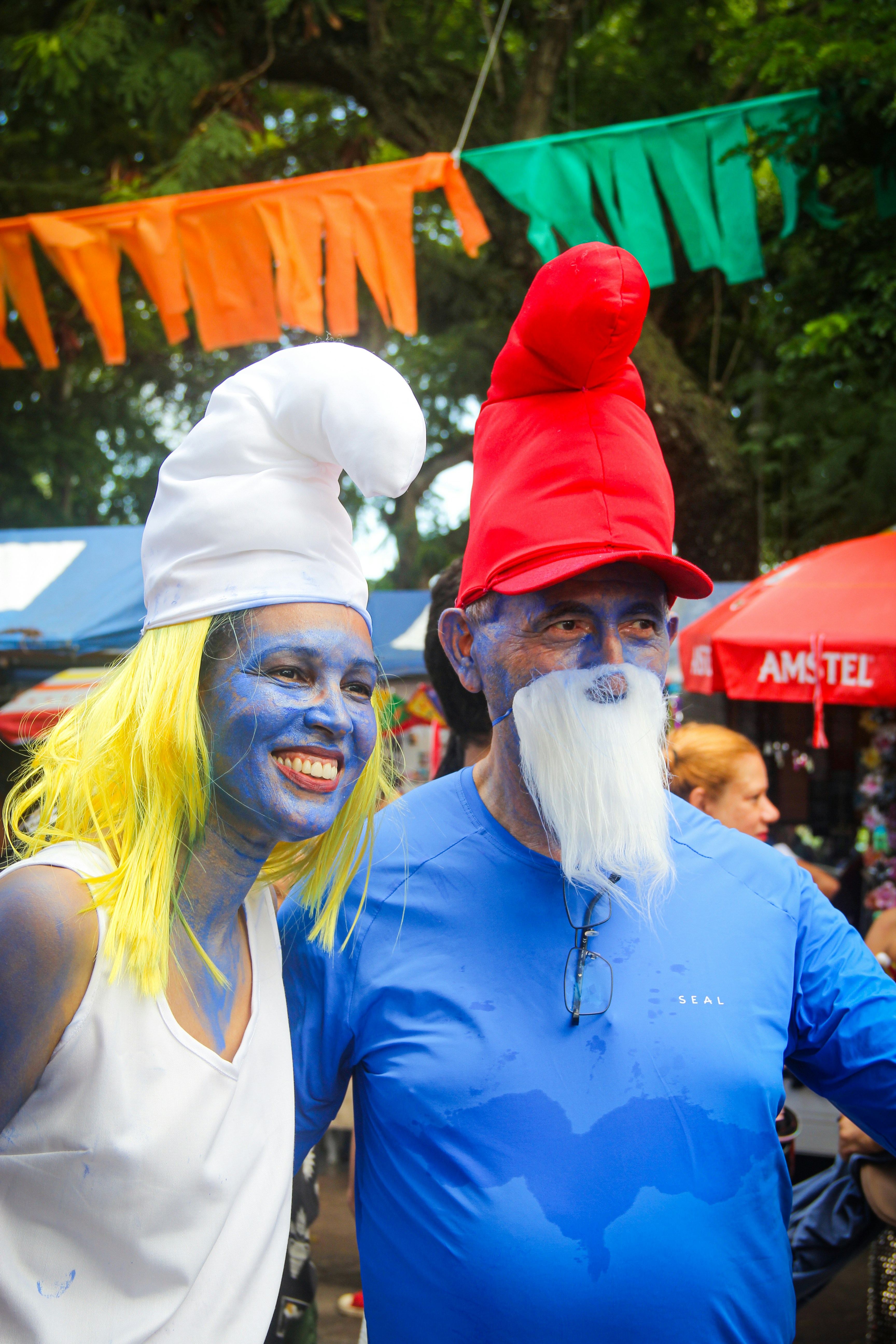 Two people dressed as smurfs at an outdoor event