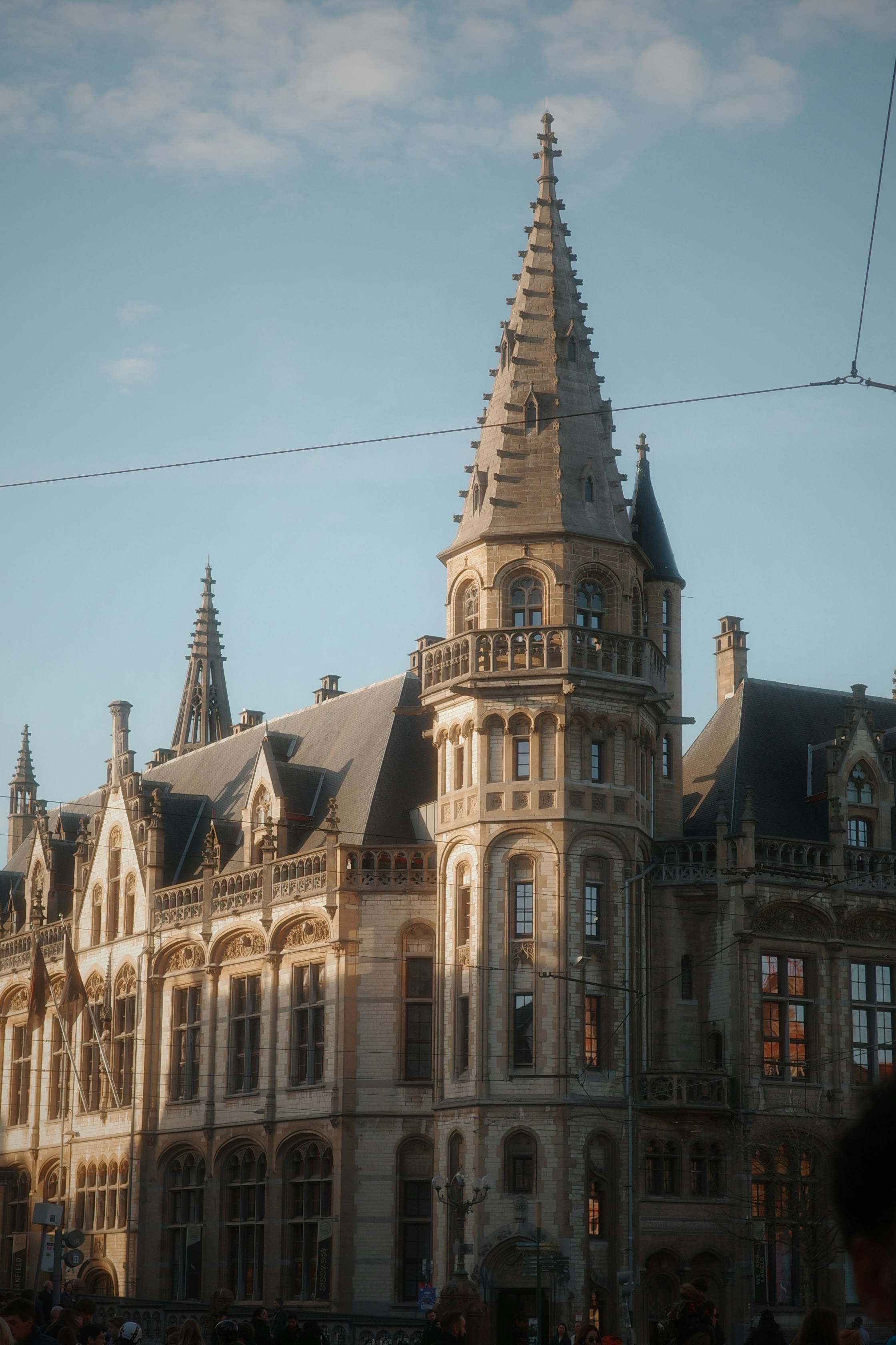 Ornate historic building with a tall spire against sky.