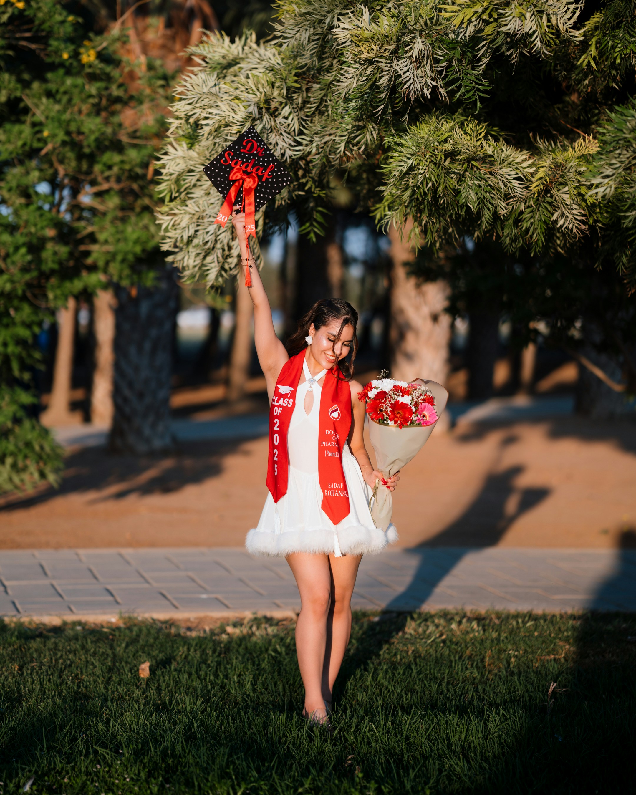 A graduate celebrates with a cap and flowers