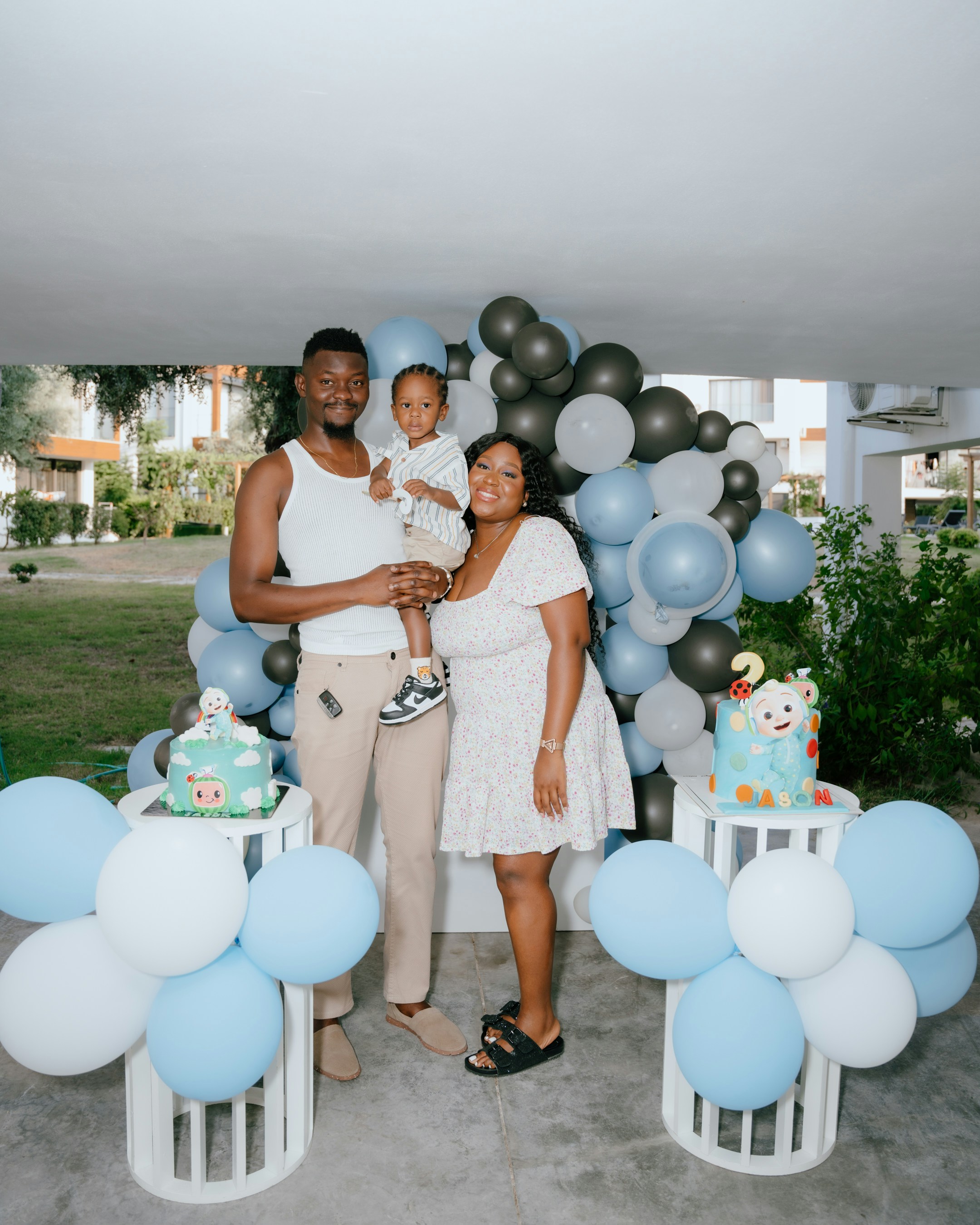 Family celebrating a child's birthday with balloons and balloons